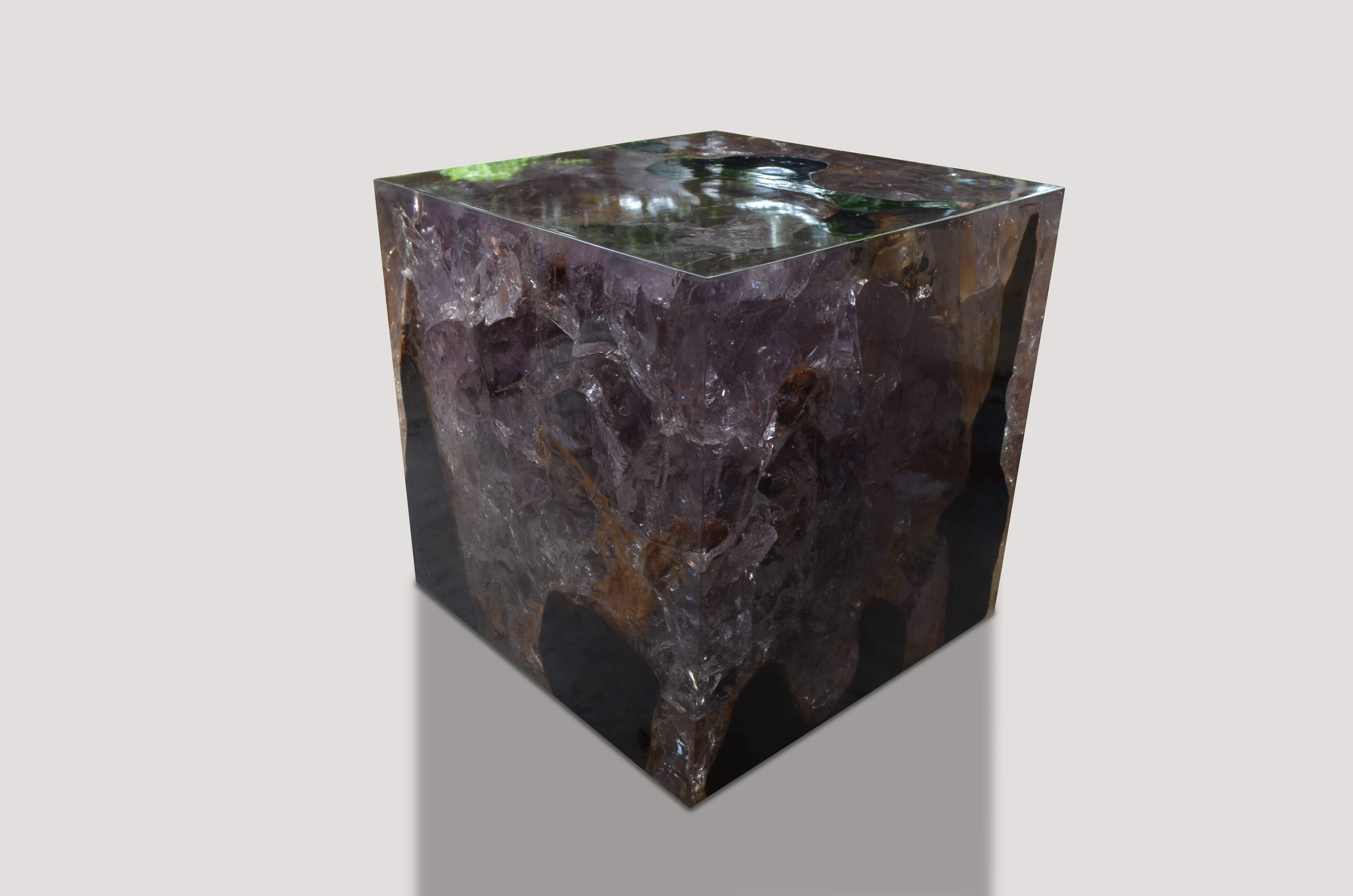 This cracked resin cocktail table is made from reclaimed teak infused with clear resin. A dramatic piece due to the depth of the resin, which resembles a unique quartz crystal with many different facets as shown here with gold, warm tones created