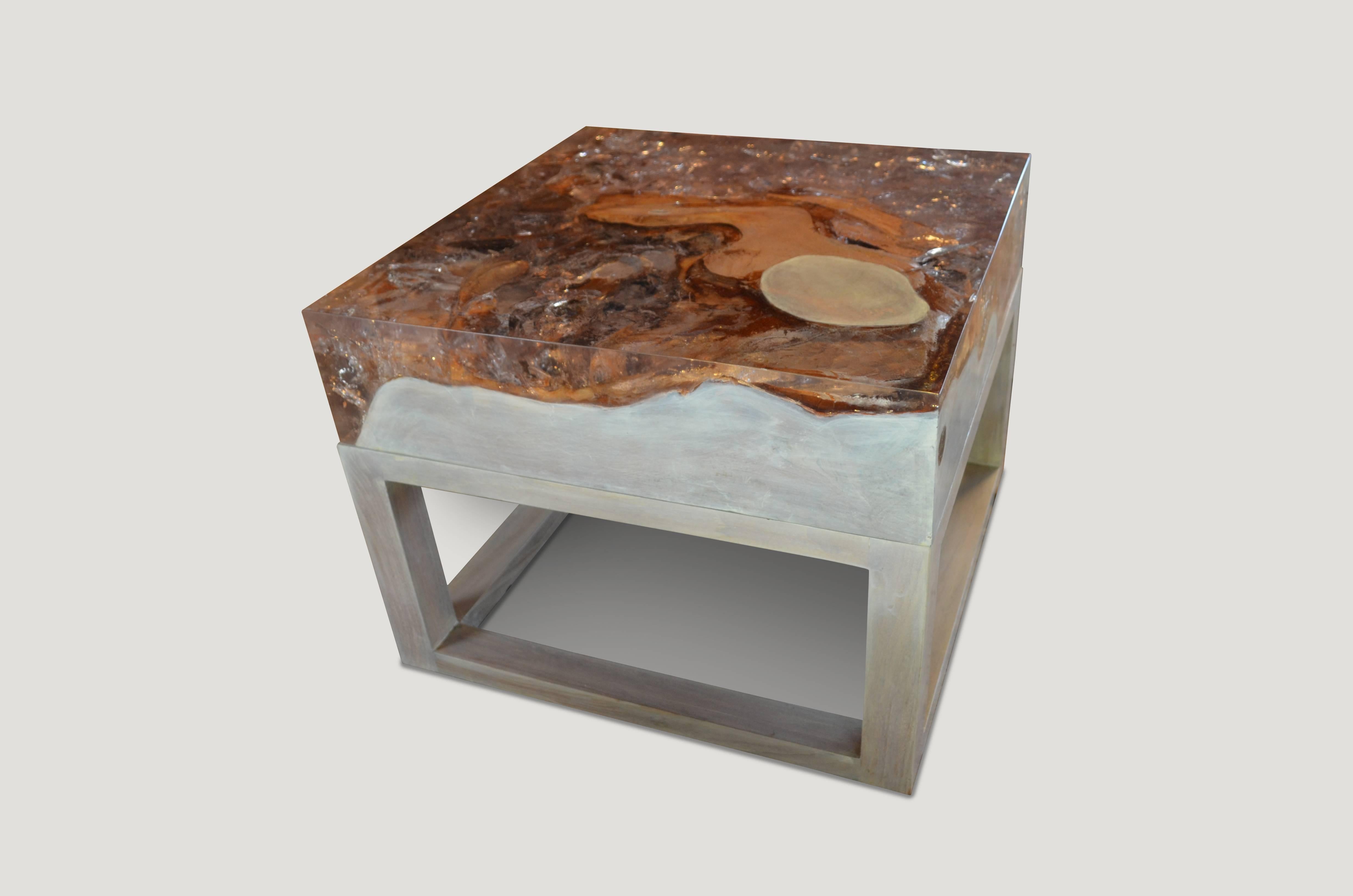 This Cracked Resin side table or coffee table is made from reclaimed teak infused with clear resin, which resembles a unique quartz crystal with many different facets, as shown here with gold, warm tones created naturally from the wood. Straight