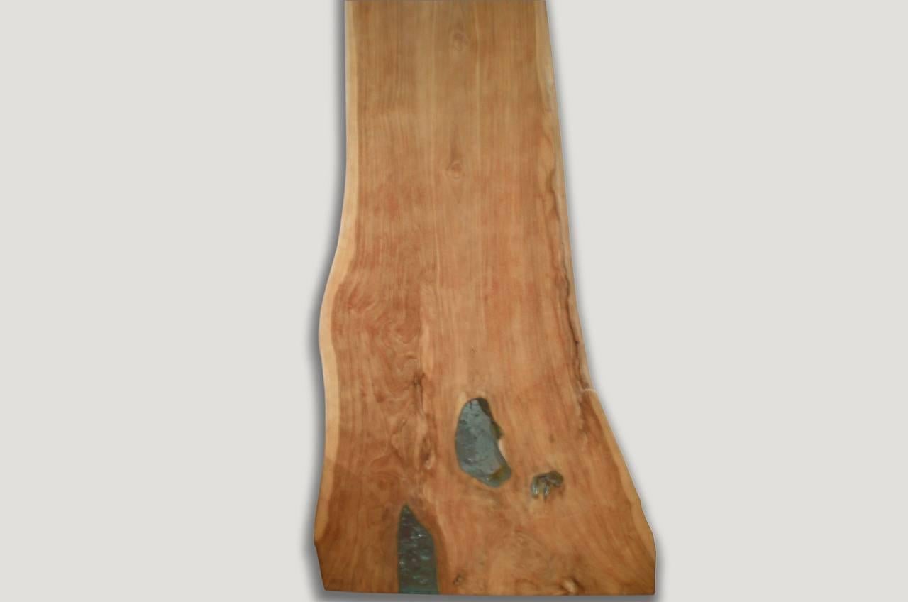 Reclaimed live edge teak panel with added aqua cracked resin. This 2.5” thick single panel can be used as a console or as a shelf.

The Cracked Resin collection is a revolutionary line of modern coffee tables, side tables and dining tables made from