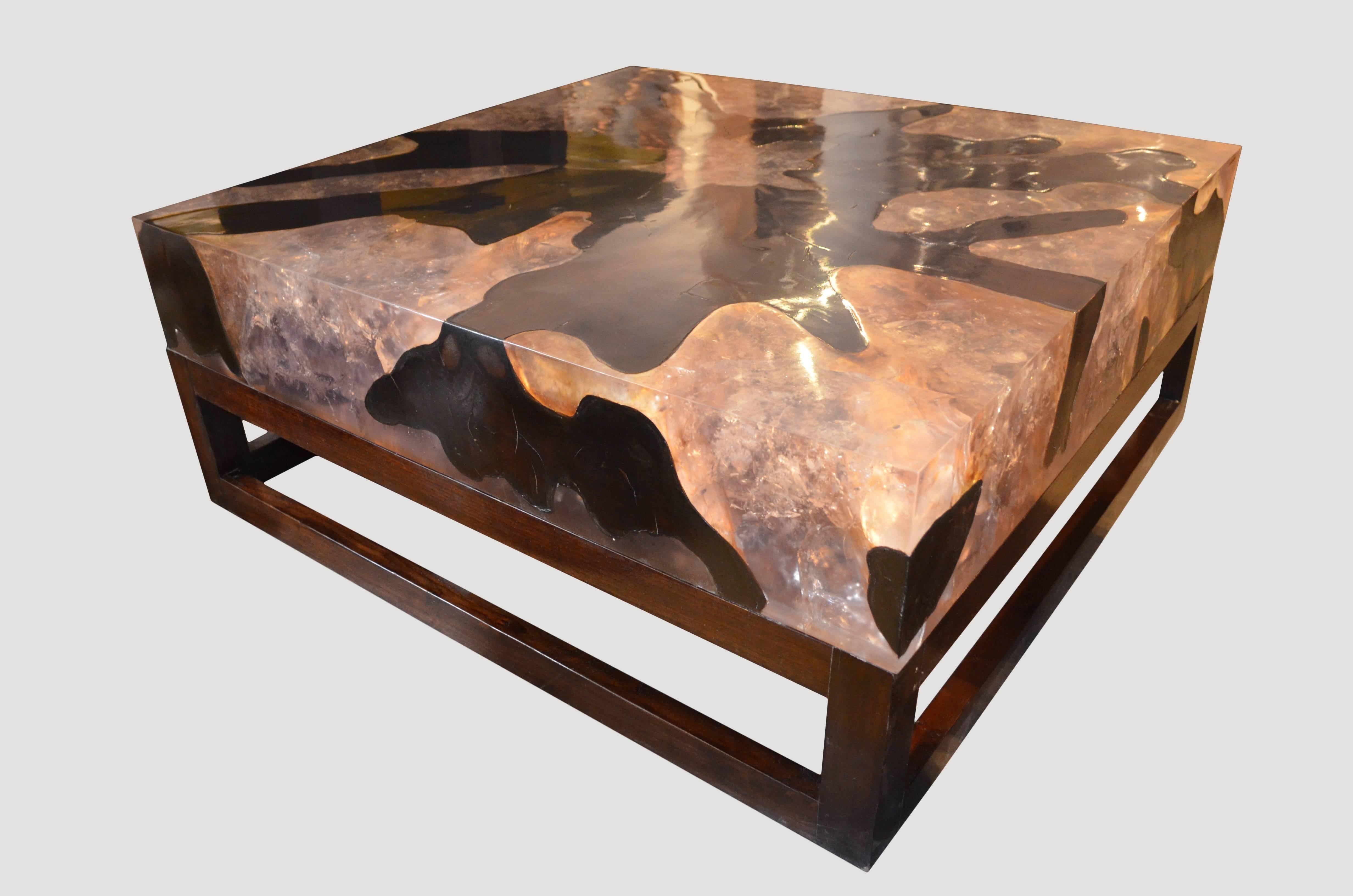 La table basse en résine craquelée est fabriquée en teck infusé de résine. Une pièce spectaculaire en raison de la profondeur de la résine, qui ressemble à un cristal de quartz unique avec de nombreuses facettes différentes. Un ajout impressionnant