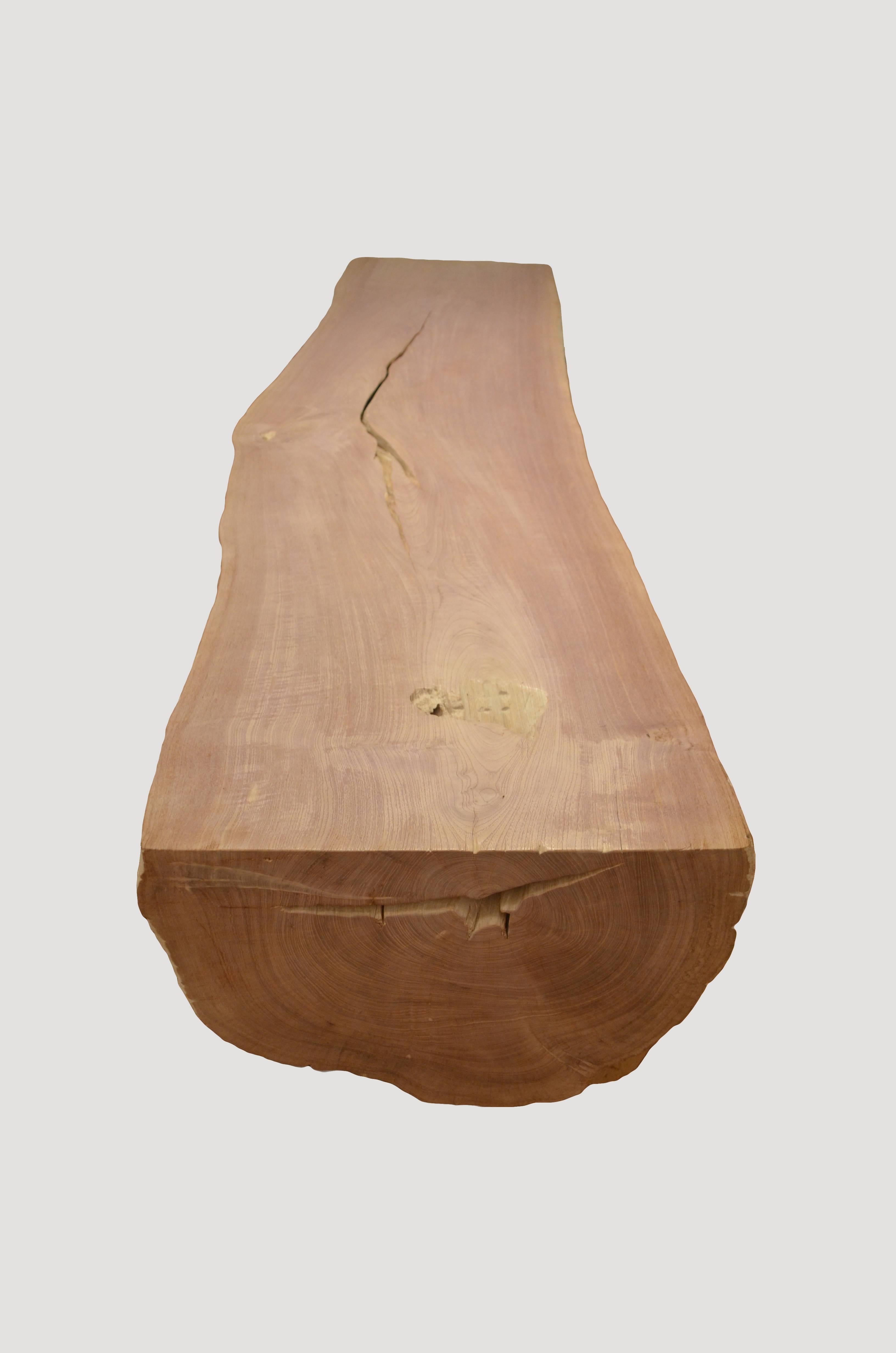 Reclaimed teak log is cut in half and carved into a stunning coffee table or bench. We have added a light shellack to the top for a contrast and for added protection. An impressive piece for a residence or public space. Custom stains and sizes