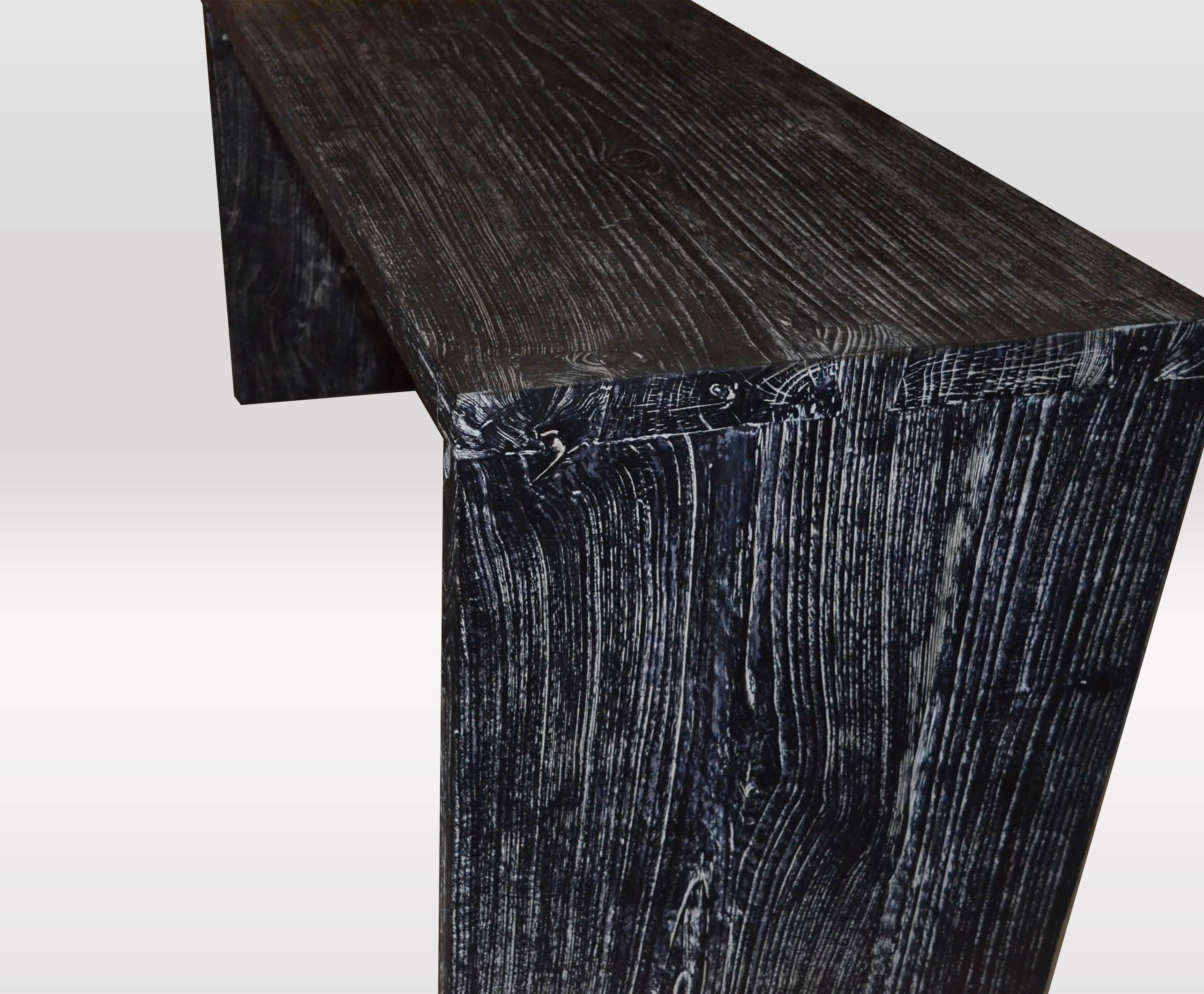 Solid teak wood console table/desk. Burnt, sanded and sealed with a cerused finish.

The Triple Burnt Collection represents a unique line of modern furniture made from solid organic wood. Burnt three times to produce a rich, charcoal finish with