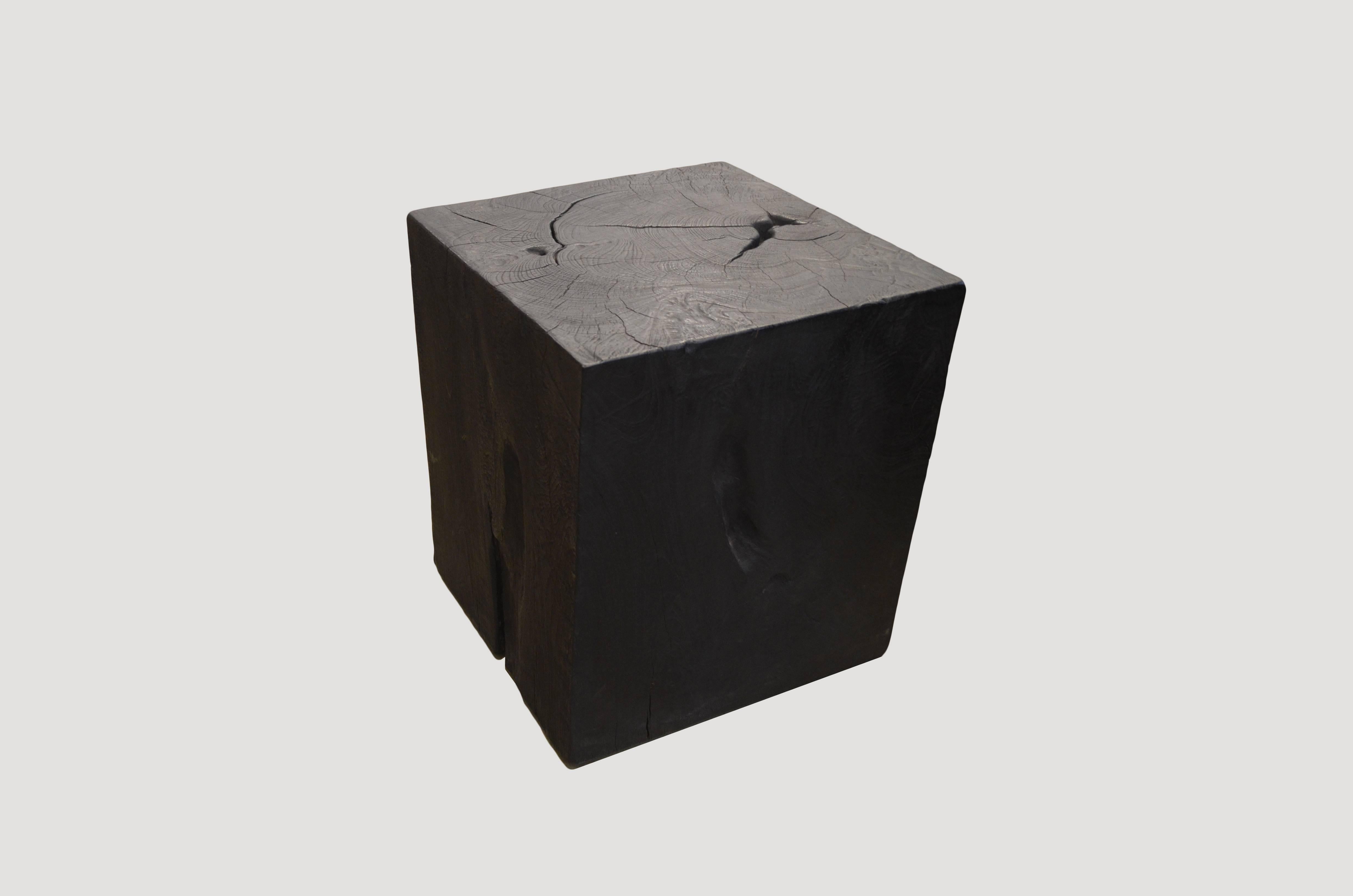 Solid teak side table. Burnt, sanded and sealed with a smooth finish.

The Triple Burnt Collection represents a unique line of modern furniture made from solid organic wood. Burnt three times to produce a rich, charcoal finish with impressive