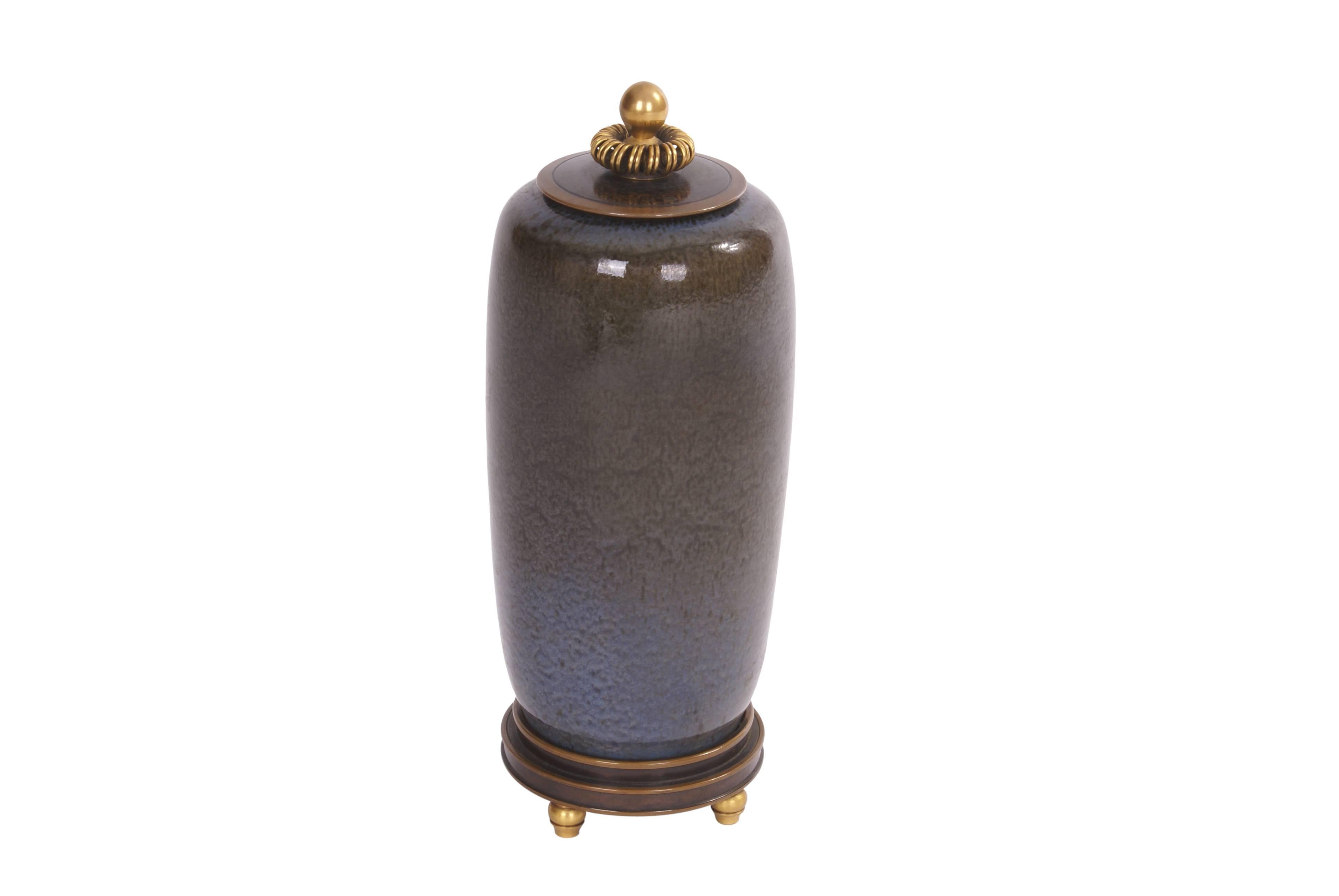 Nils Thorsson cylindrical stoneware lidded jar. Decorated with Clair de Lune glaze. Signed monogram, 4272. Royal Copenhagen. Made 1962. Lid and base of patinated and partly gilded bronze. Stamped monogram KA for Knud Andersen. This piece is unique.