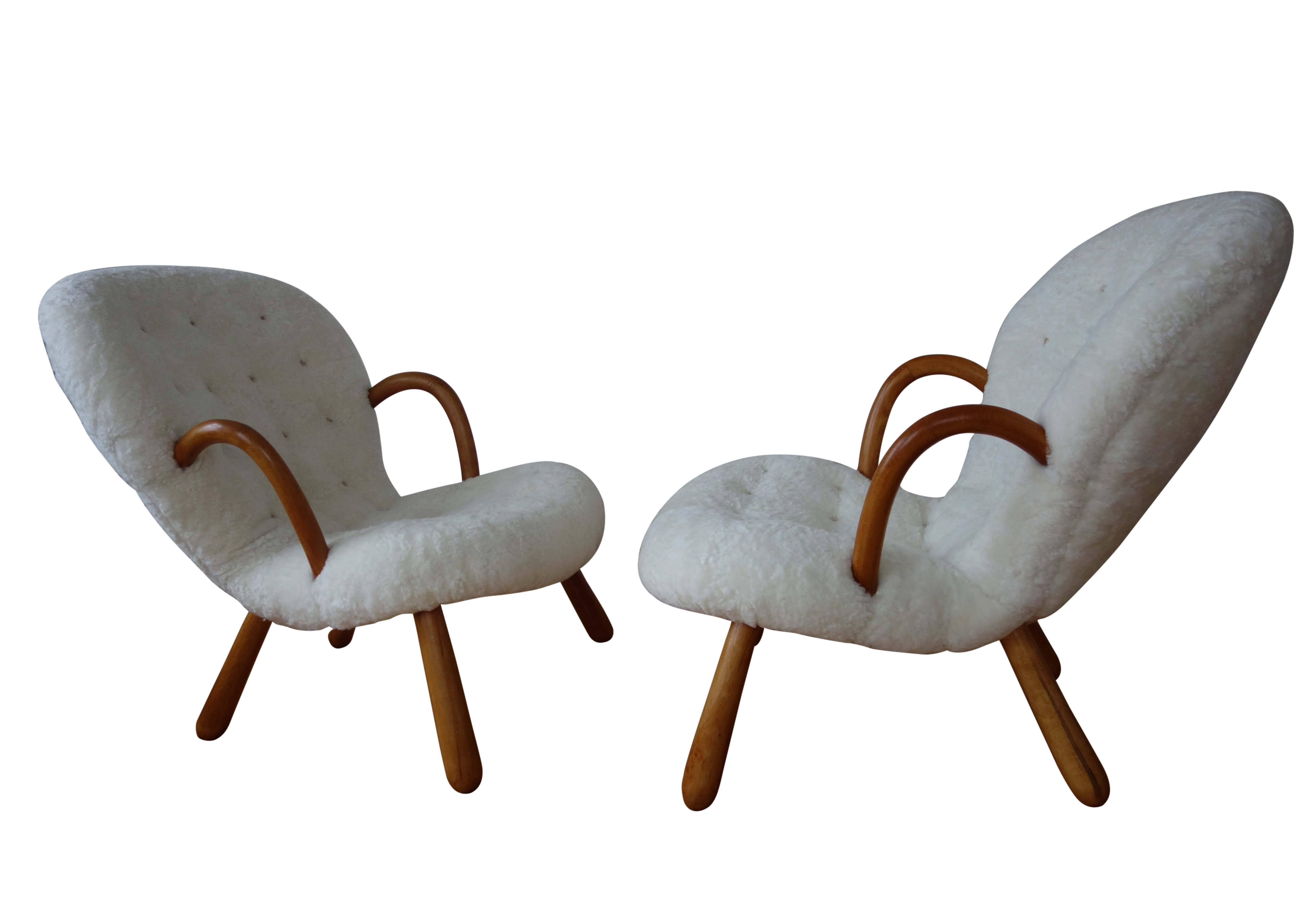 Pair of Philip Arctander 'clam' easy chairs in sheepskin and beech. Buttons in natural leather.

Price is for the pair.

Single chair is also available. Contact for details.