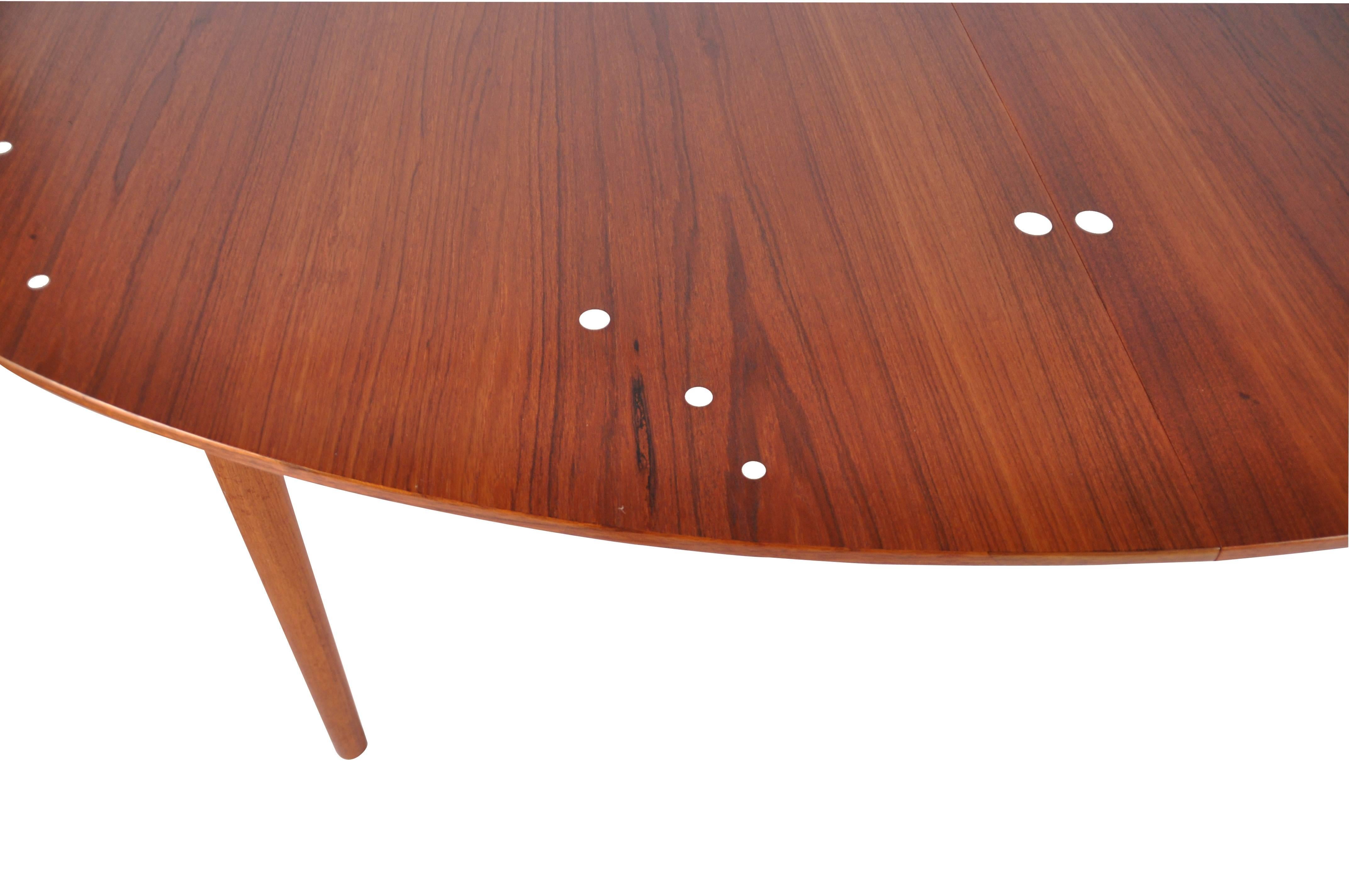 Finn Juhl 'Judas' dining table in teak for Niels Vodder with two extension leaves and silver inlays for cabinetmaker Niels Vodder. Designed 1948.

Note that this table was made in two sizes and this is the large version with a width of 140 cm (55