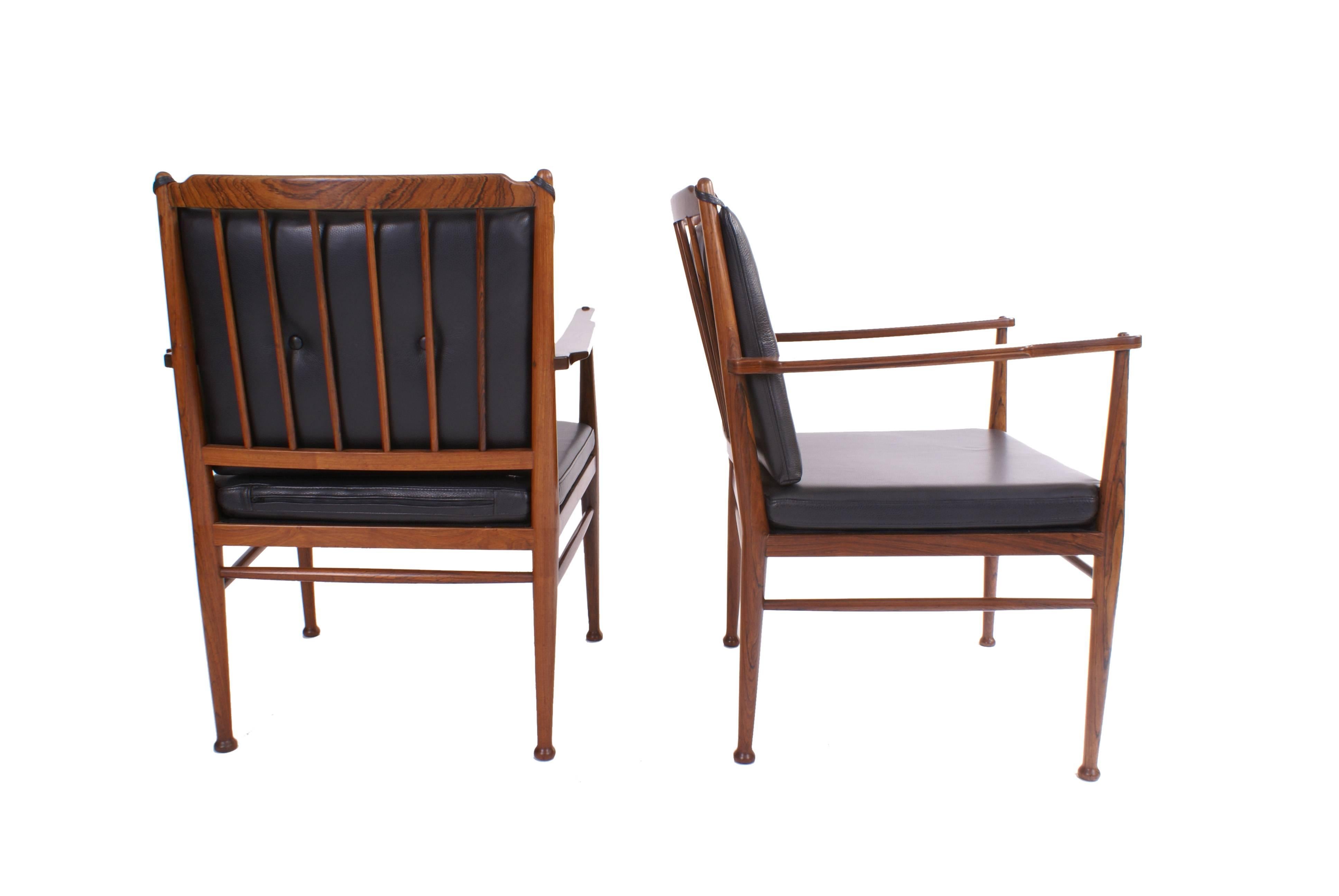 Peter Hvidt & Orla Mølgaard Nielsen pair of solid Brazilian rosewood armchairs, back with vertical slats. Loose cushions in seat and back upholstered with black leather, back cushion fitted with buttons.

These examples made 1950-1960's by master