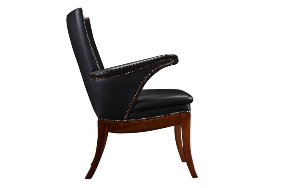 Frits Henningsen chair with Cuban mahogany frame. Sides, seat and back upholstered with patinated black leather, back fitted with buttons. Made and designed by Frits Henningsen.

Literature: Noritsugu Oda: "Danish Chairs", ill. p. 42.