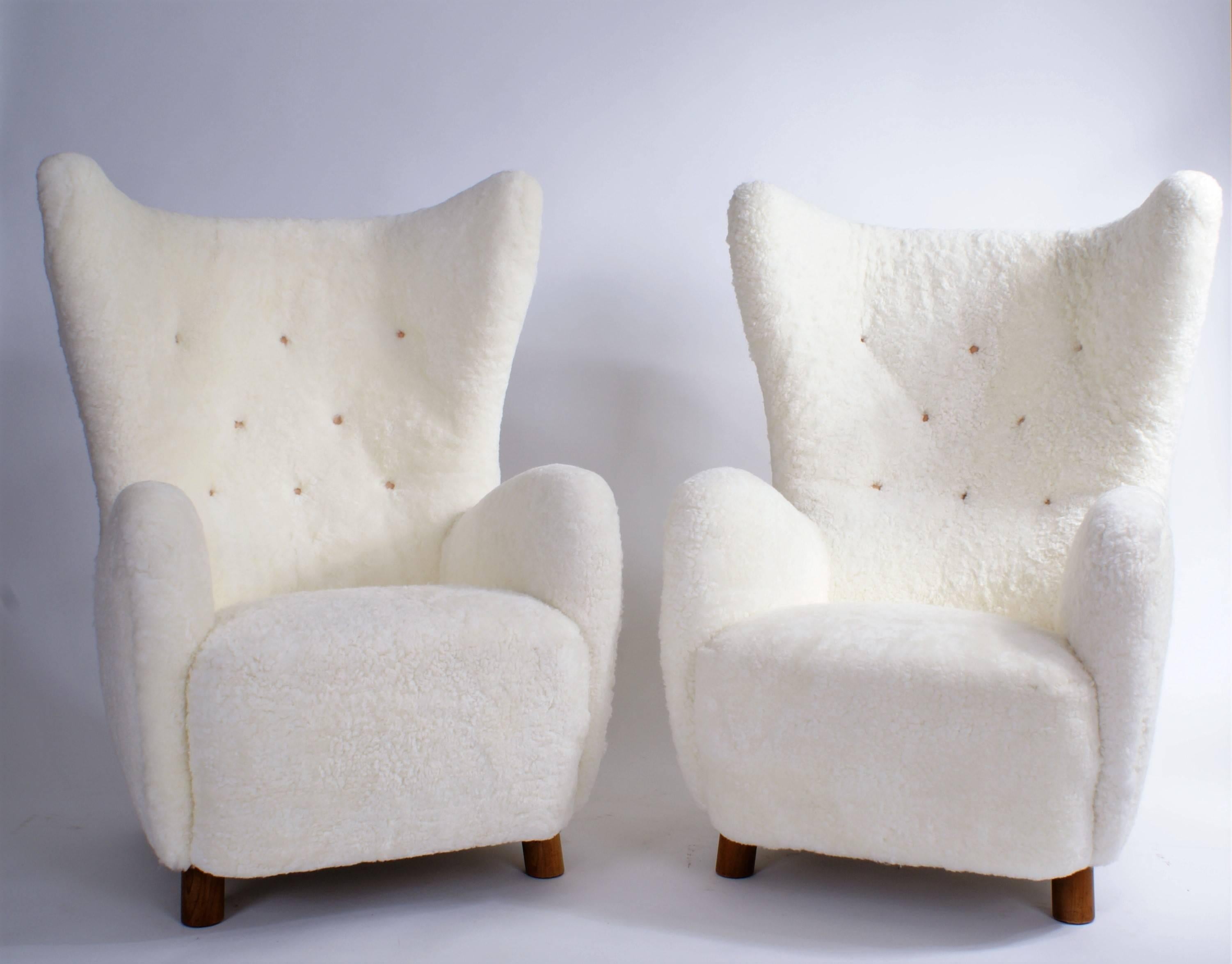 Pair of Mogens Lassen 'wing' easy chairs in sheepskin, legs of beech, 1940s.

Price is for the pair.

Lliterature: Dansk Boligkunst 1947, Vol. II, Bernadotte & Lehm-Laurson, pg. 212.