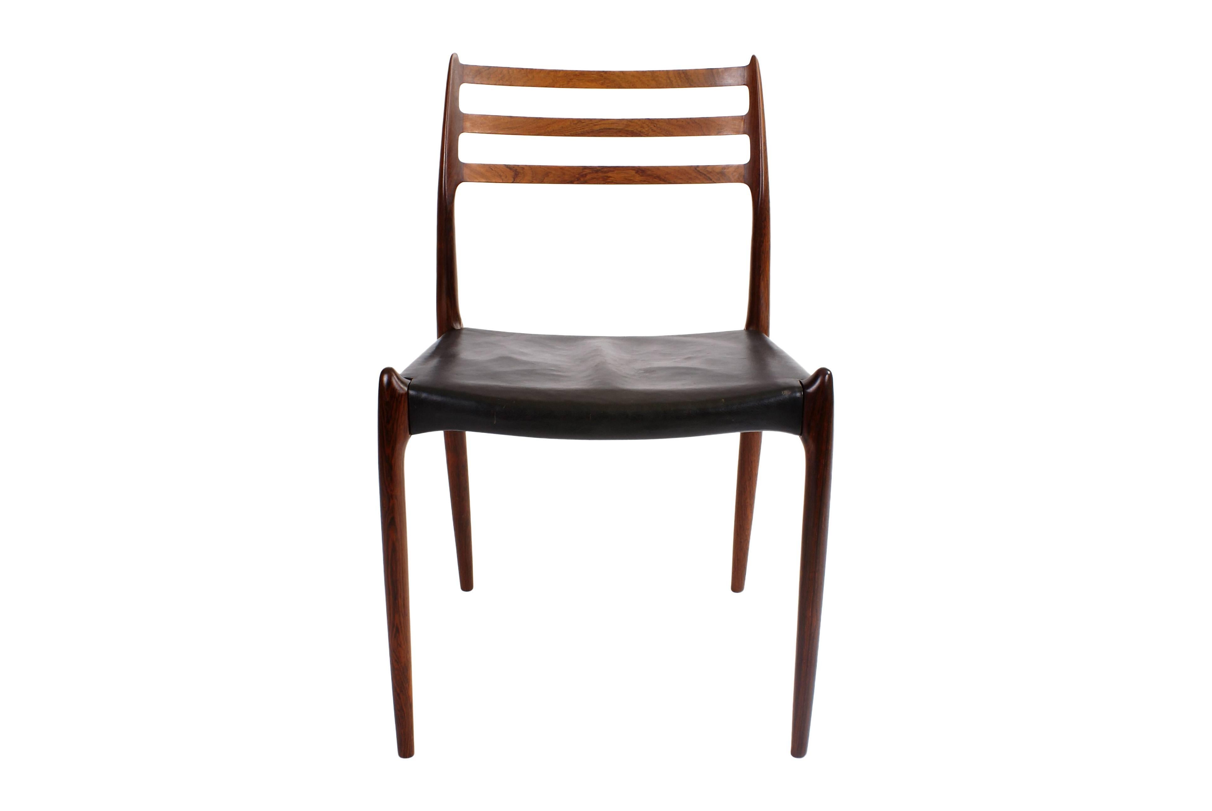 Niels O. Møller set of ten Brazilian rosewood dining chairs, horizontal bars in back. Seats with original black leather. Model 78. Designed 1962. Made by J. L. Møller.

The set is in excellent condition.

Price is for the set of ten chairs.