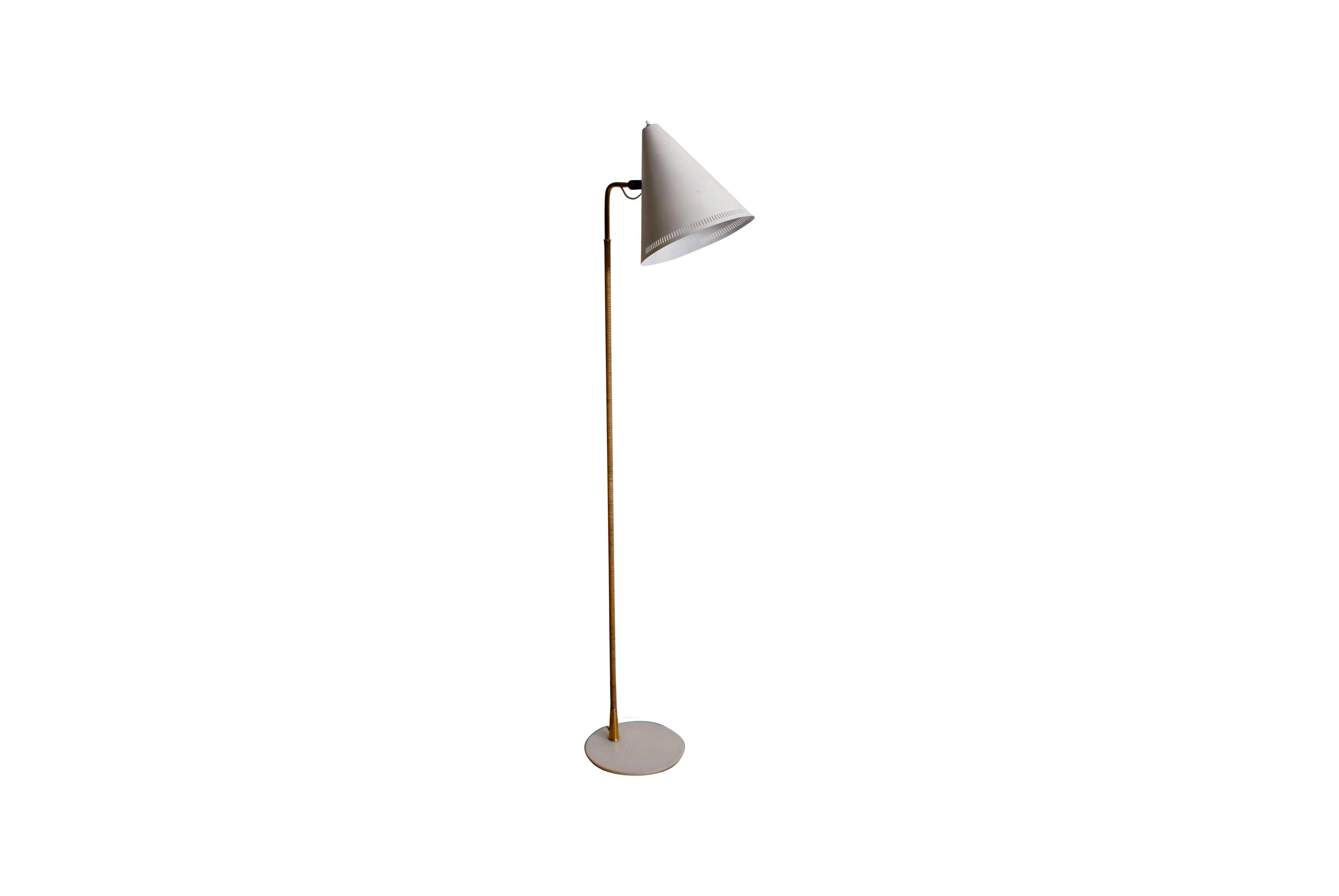 Paavo Tynell floor lamp in brass, cane and metal for Idman, Finland. Model K10-10, circa 1950s. Shade is adjustable.

Impressed with manufacturer’s mark: 'Idman'.

Excellent condition.