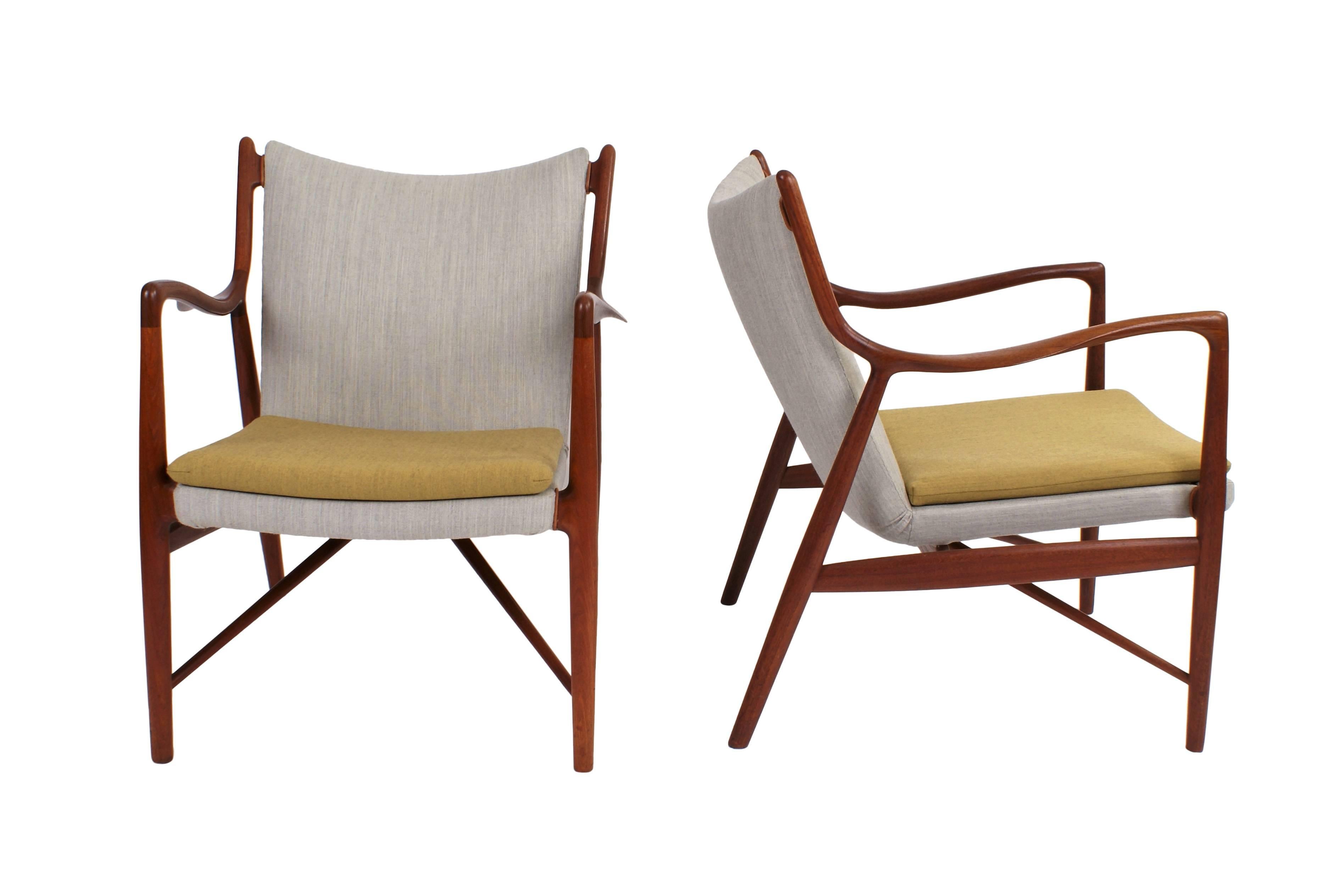 Pair of Finn Juhl NV45 chairs in teak made and stamped from master cabinetmaker Niels Vodder. Designed, 1945.

The chairs are re-upholstered in fabric. Underside of each armchair branded and impressed with 'CABINETMAKER Niels Vodder/COPENHAGEN