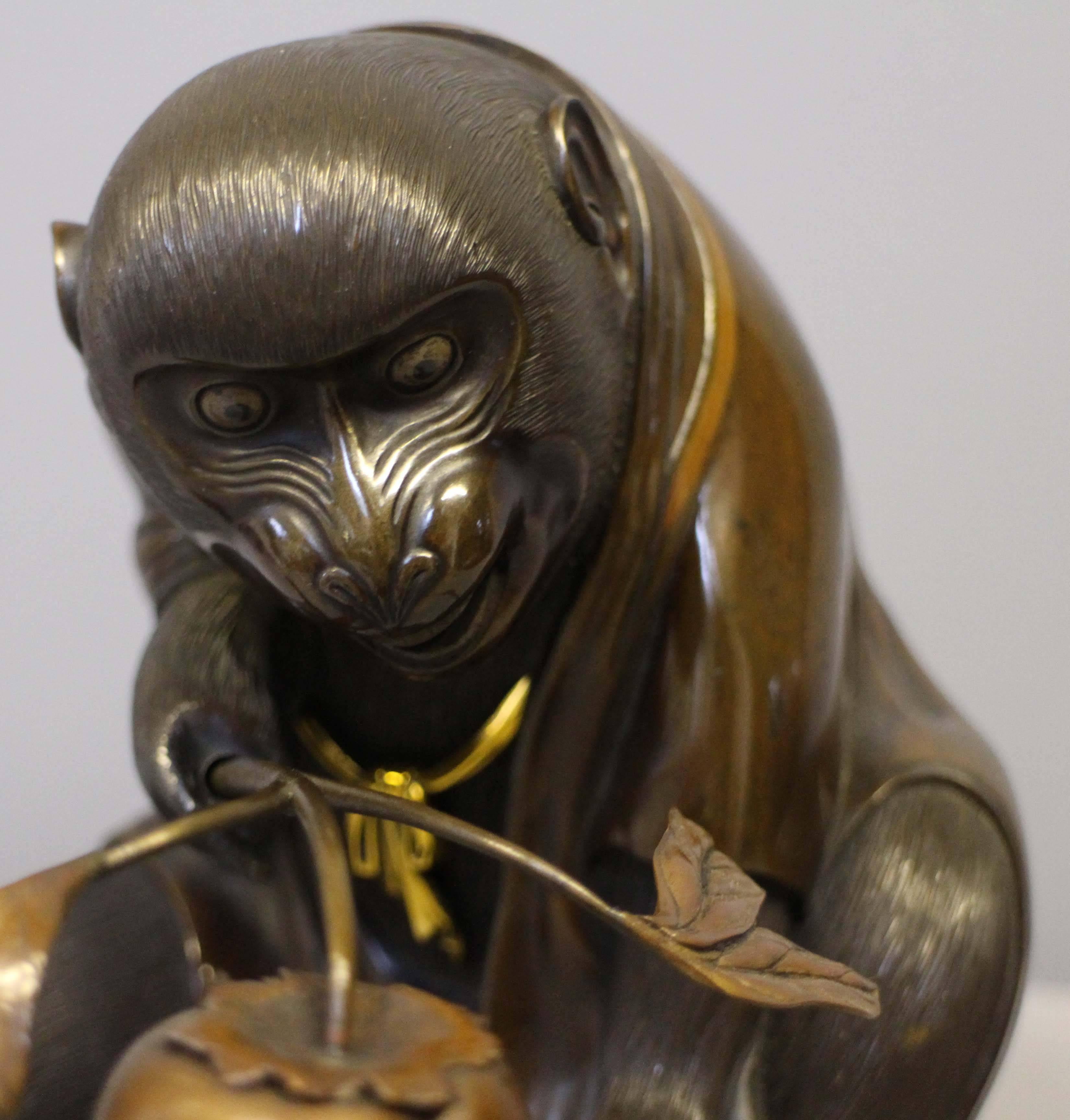 Late 19th Century An unusual Antique Japanese Bronze Monkey in an origami kimono holding a peach For Sale