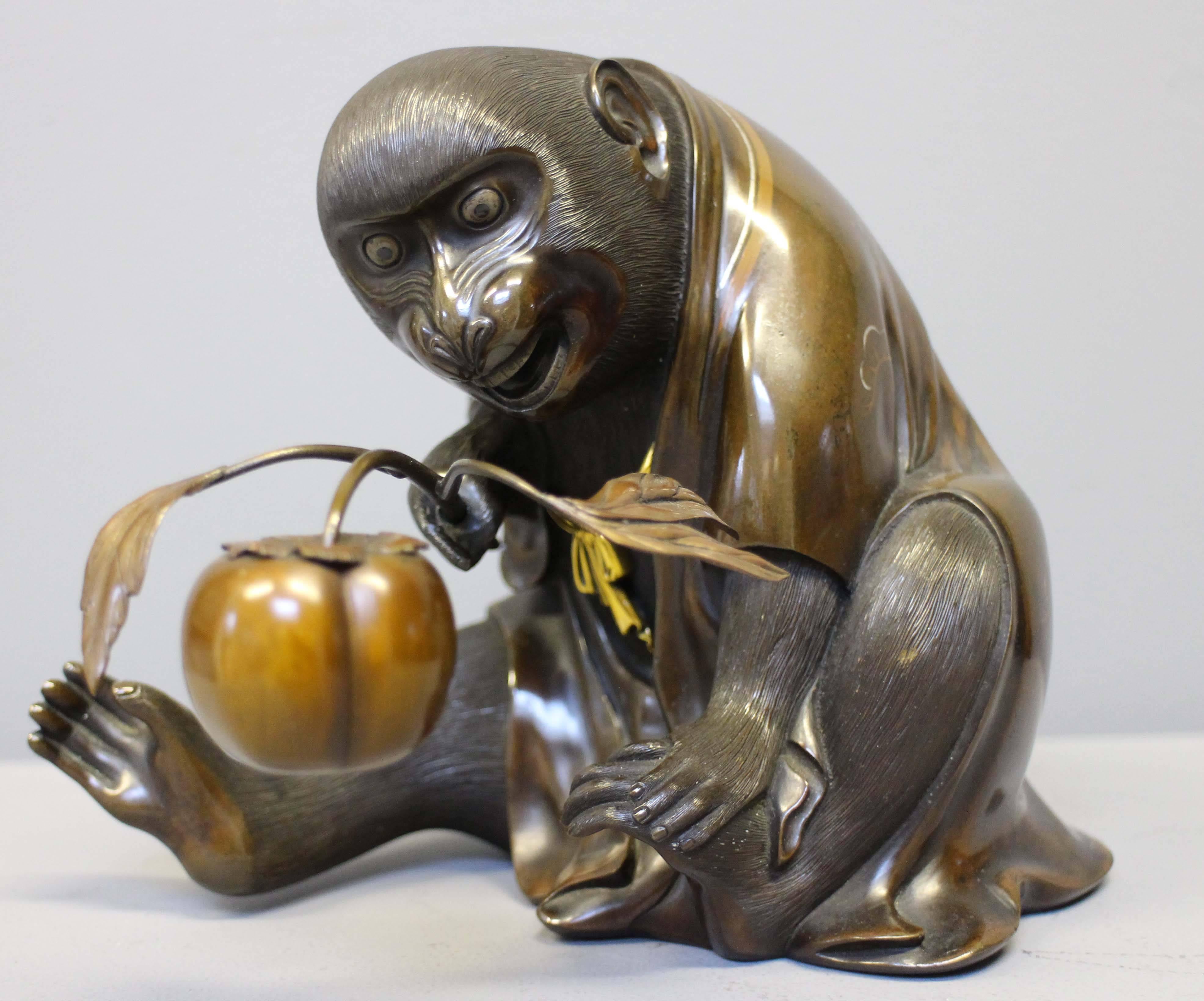 An unusual Antique Japanese Bronze Monkey in an origami kimono holding a peach For Sale 1