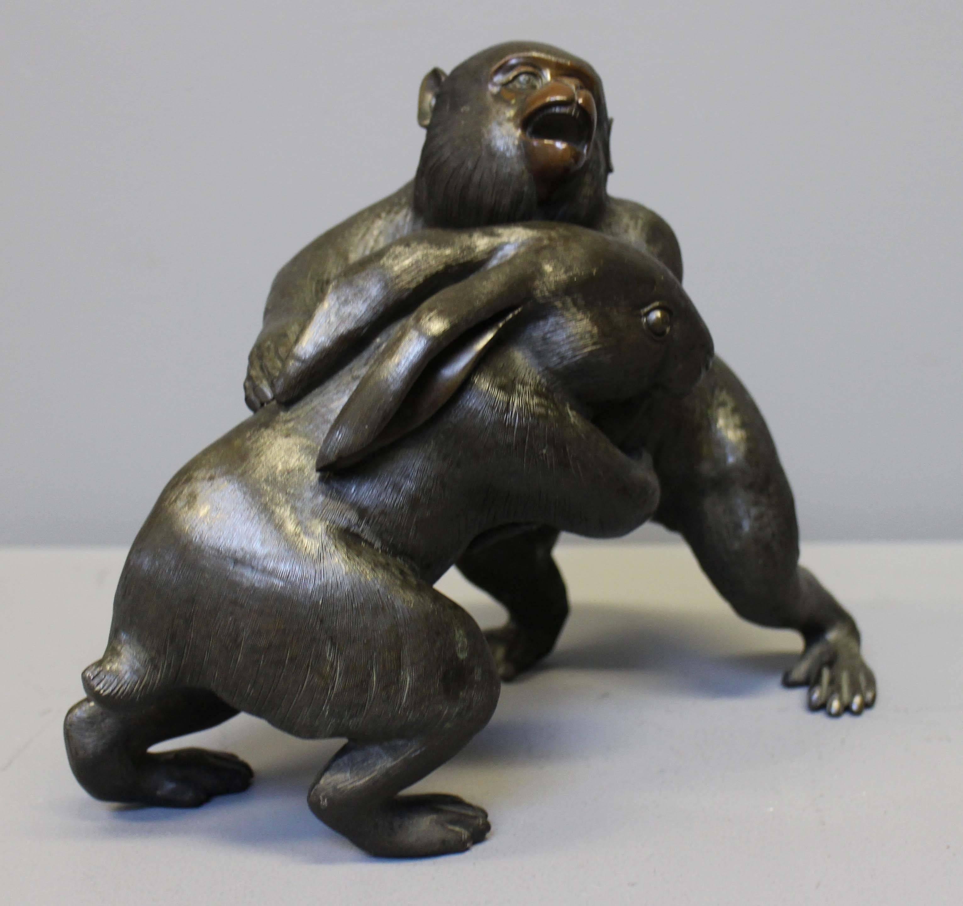 An amusing antique Japanese bronze of a Monkey and a Rabbit wrestling. The subject seems to have been inspired by the 12th century Chōjū-jinbutsu-giga scrolls of Kyoto. The scrolls depict anthropomorphic animals taking part in a ceremony and