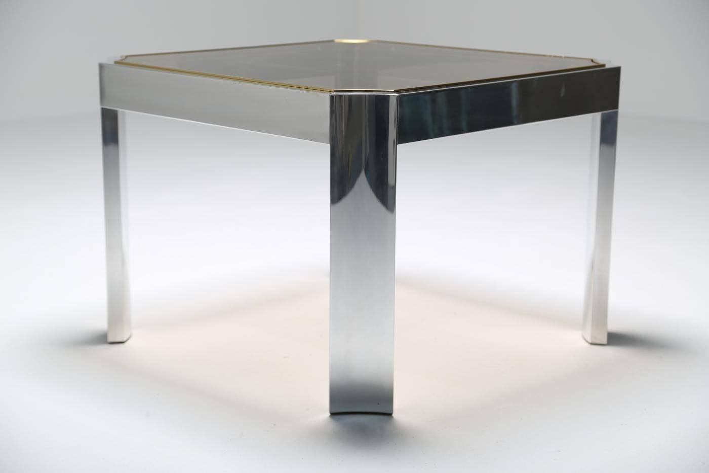 An aluminum and glass side table or coffee table with brass trim in the style of Ron Seff. We have also listed a larger coffee table in the same series, see our other listing. Easily shipped anywhere in the world.