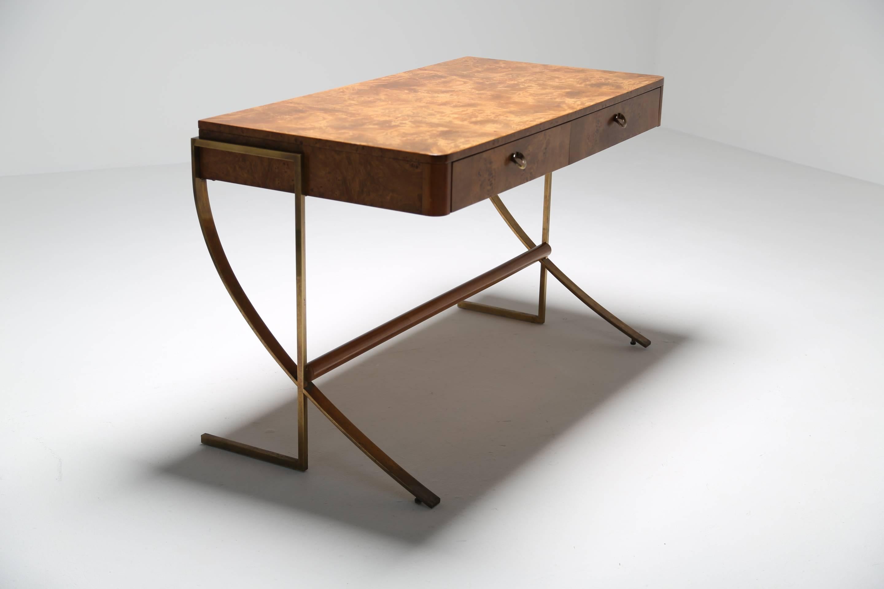 A beautiful burl wood and brass desk by Hickory White in the style of an Art Deco desk by Rene Herbst. A two-drawer letter writing or home office sized desk with sloping brass leg.