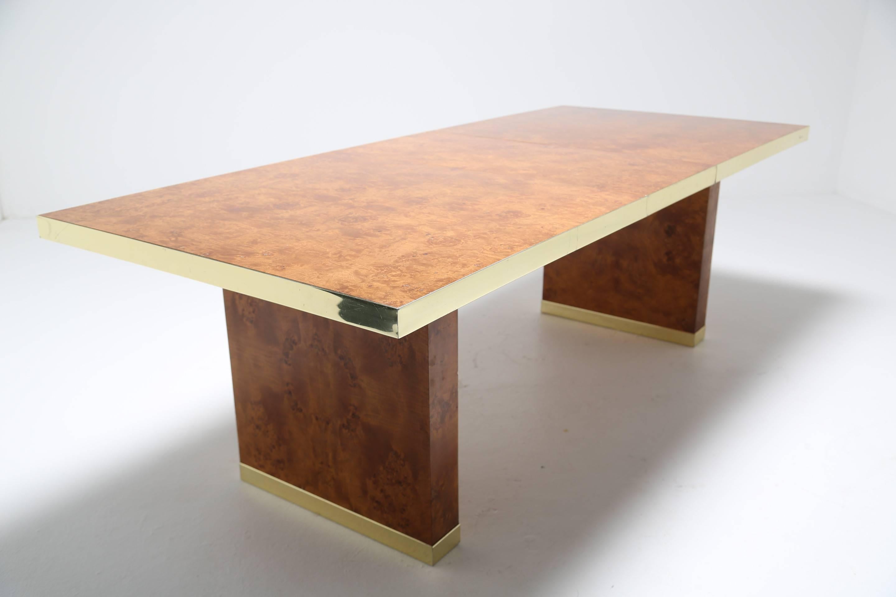 This handsome original (signed) Pierre Cardin dining table is made from a beautiful burr maple and trimmed in brass. It is 229.5 cm long when fully extended and can comfortably seat eight to ten people. The easy to remove leaf on this extendable