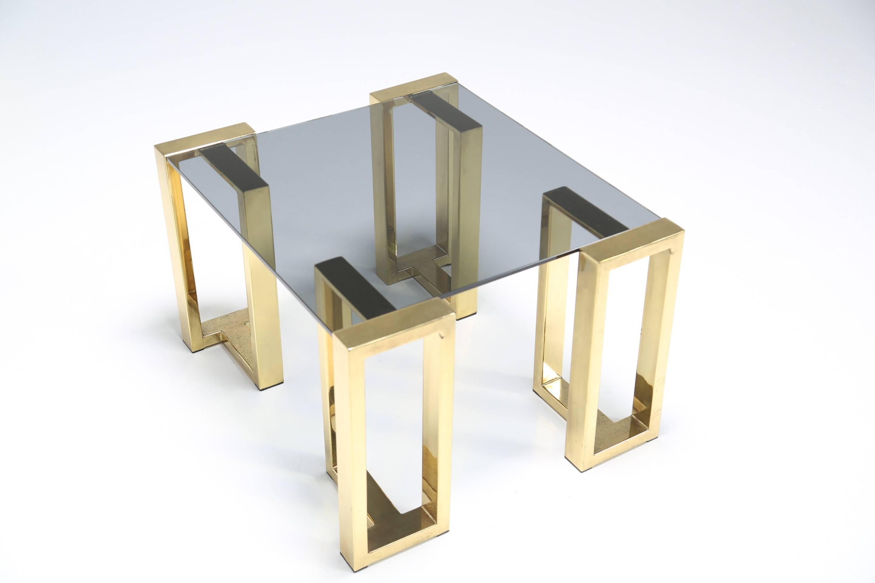 A very elegant brass and glass coffee table made up of separate legs that hold a glass tabletop in place. This would probably work best as an end table either beside a sofa, chair or bed. It is a small size coffee table or decent size end table.