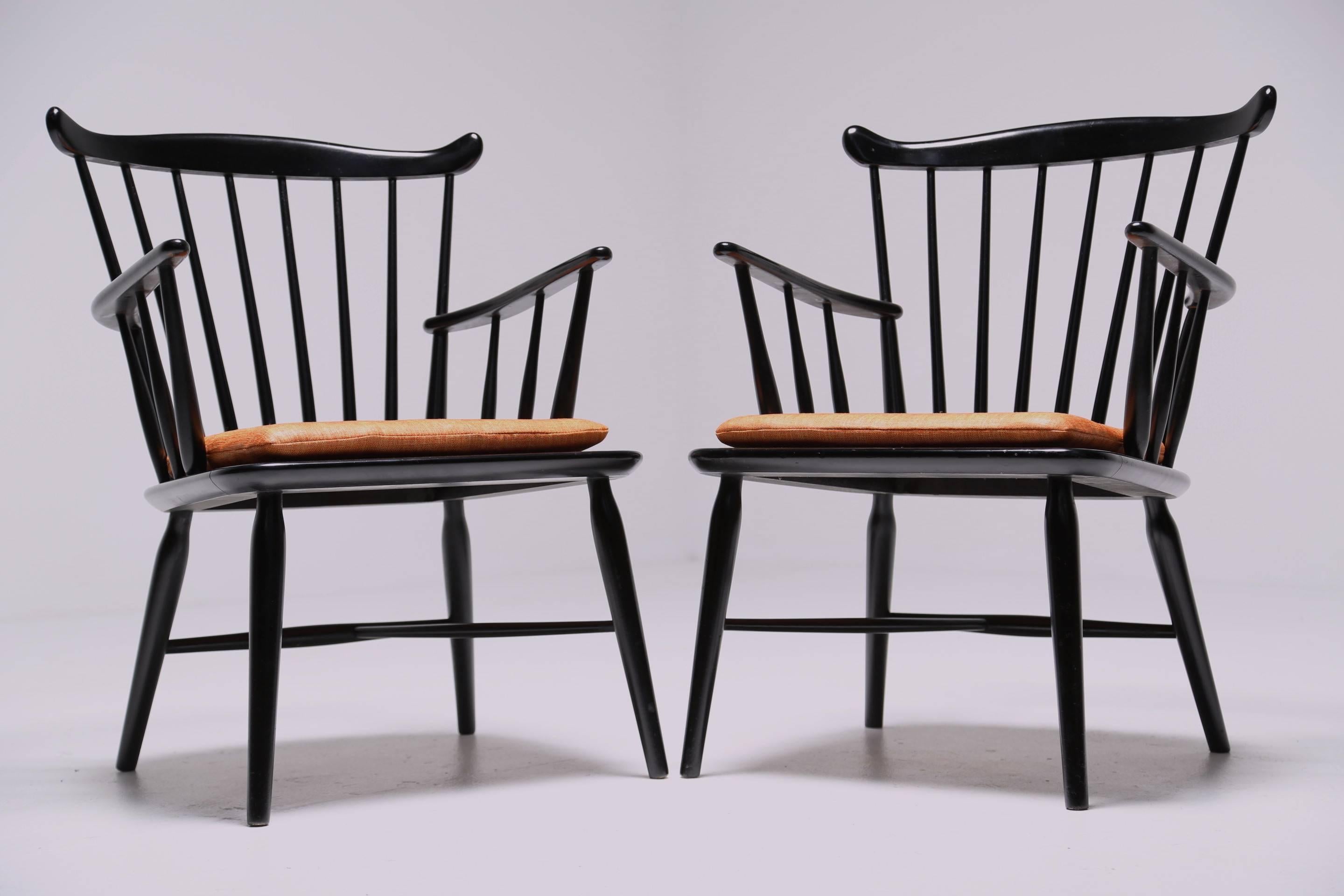 A pair of 1960s Børge Mogensen Windsor armchairs for FBD Mobler with orange linen seat pads and black lacquer frames. A super stylish and comfortable pair of armchairs in excellent condition.