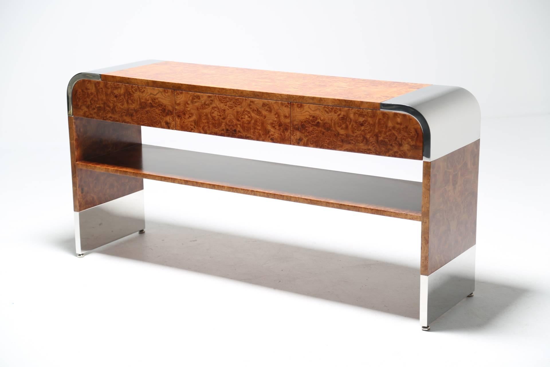 A stunning burl wood and chrome console table designed by Irving Rosen and manufactured by Pace Collection sometime in the late 1970s or very early 1980s. A very stylish and functional piece with drawers for storage and plenty of room on top to