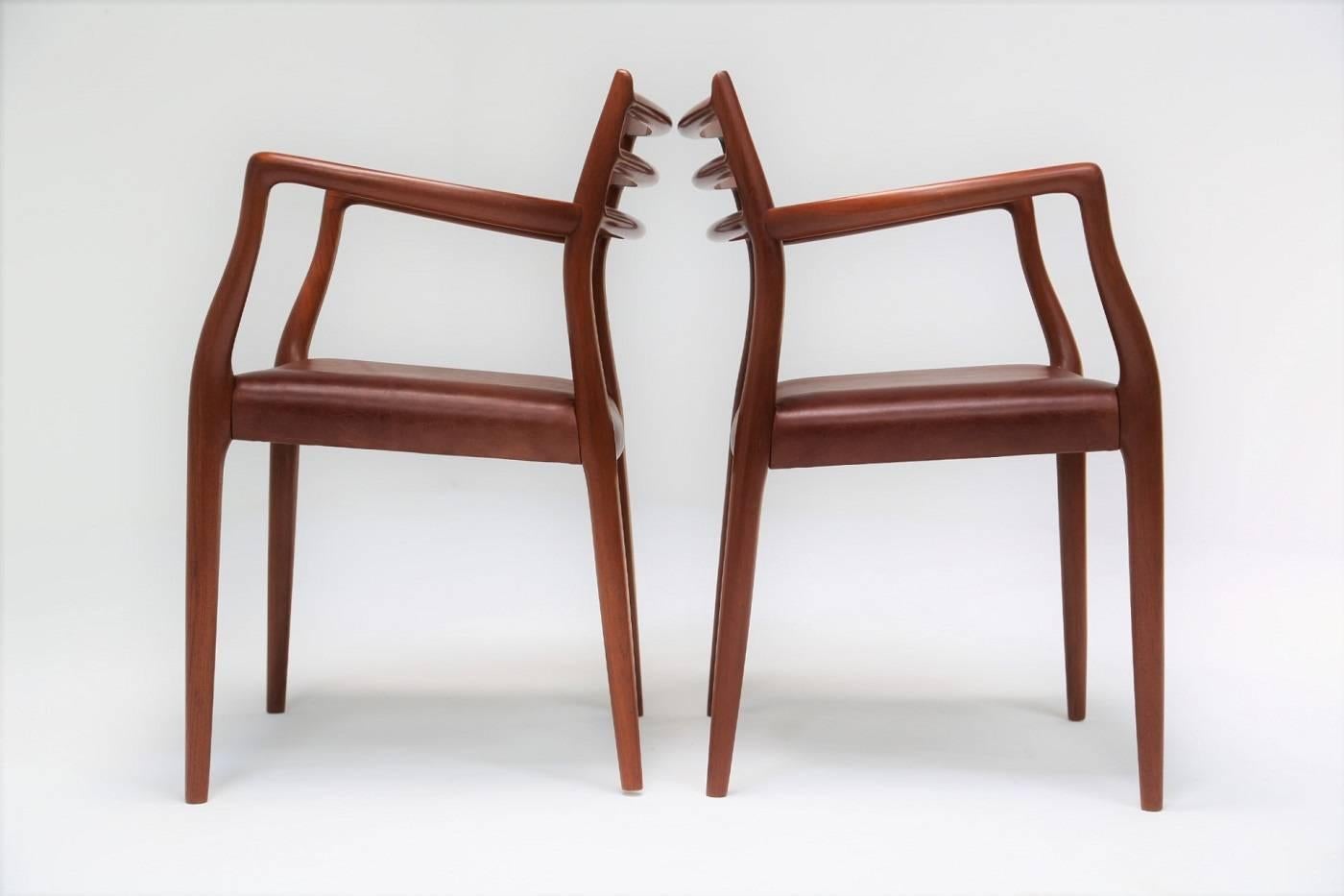 This pair of Mid-Century carvers by Niels O. Moller are an absolutely stunning example of this cherished Danish Designer's artistry. These model 62 chairs have been crafted from the most beautiful quality teak which has a great tone and good clear