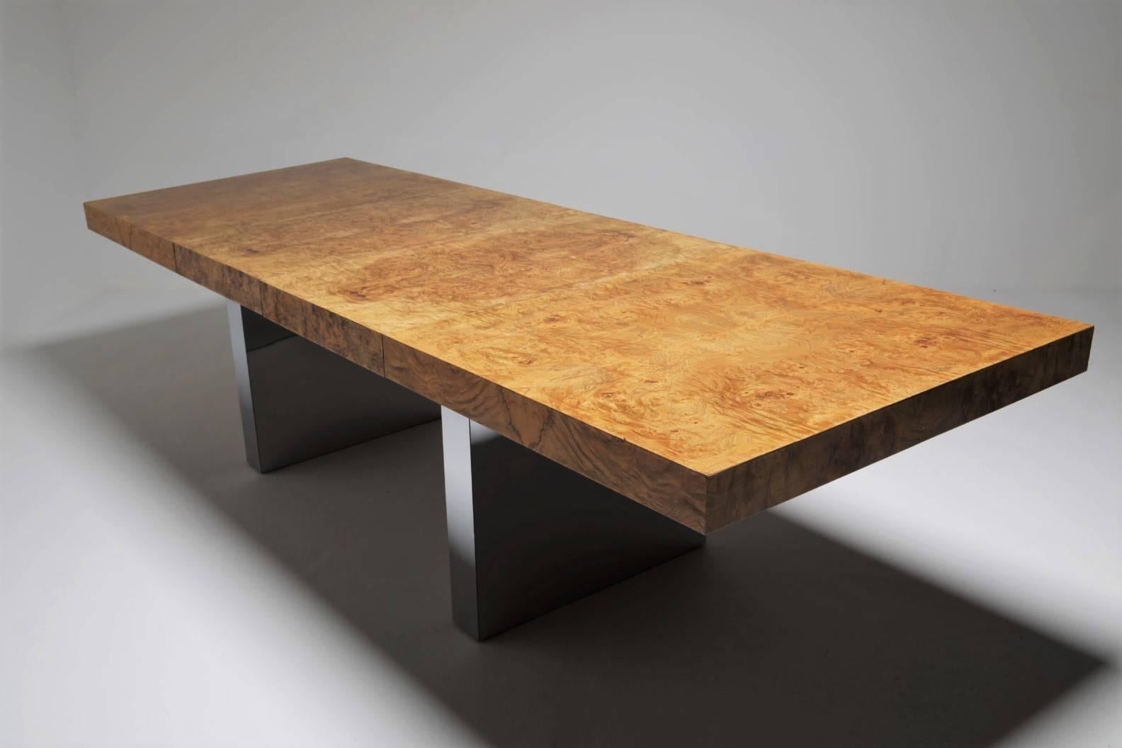 This is a wonderfully dramatic burl dining table by Milo Baughman for Thayer Coggin. The burl wood top has beautiful grain and a gorgeous warmth to it. There is a Dual pedestal polished chrome base that really reflects the light yet belies the