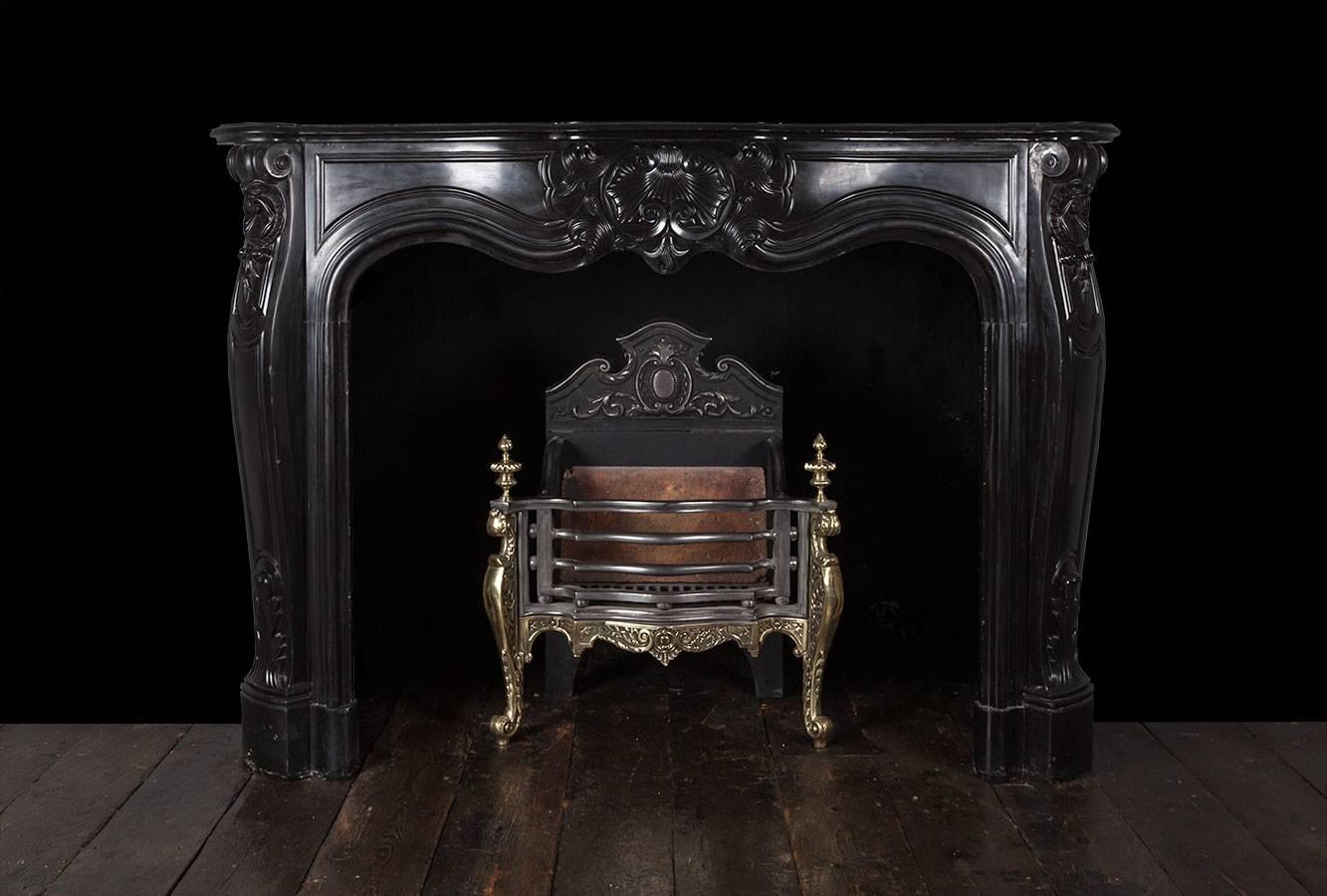 Carved Antique Louis XV Black Marble Fireplace For Sale