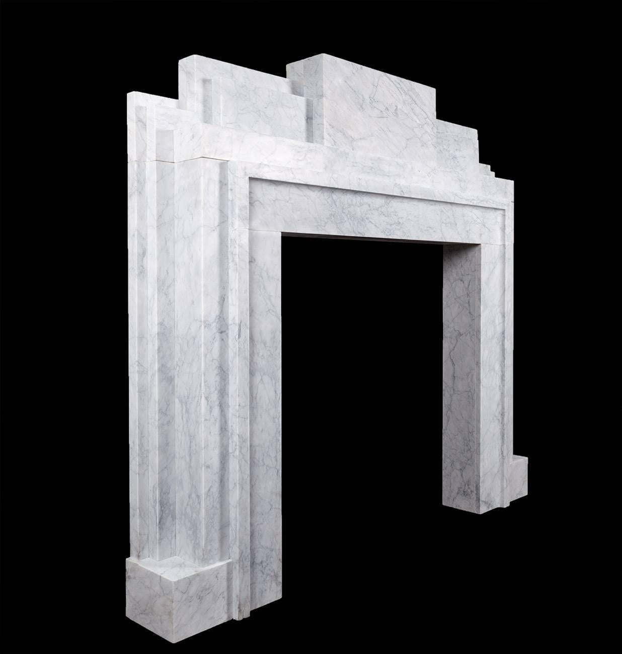 This mantelpiece made by Ryan & Smith is a faithful copy of an original 1930s Art Deco piece. Handmade from attractive and nicely veined blocks of Italian Carrara marble.

The Art Deco style combines modernist styles with fine craftsmanship and