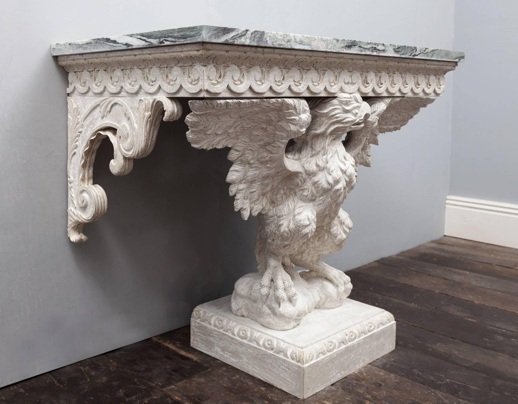 A magnificent pair of eagle console tables in the George II Palladian style. The Connemara marble tops are of the finest cut, displaying great veining and variation of colours. Each marble top is supported by a vitruvian scroll frieze, under two