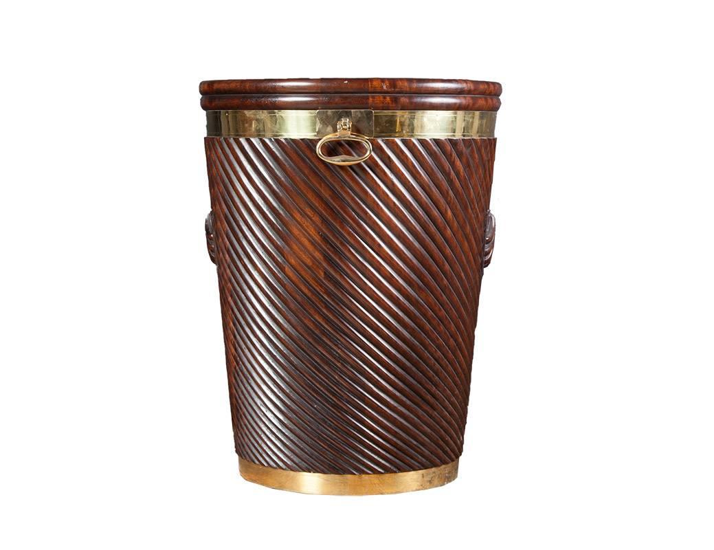 Irish turf bucket in the late Georgian style.

Large mahogany Irish turf bucket with carved scallop shell detail. The richly colored mahogany body has been polished dark and slightly distressed to simulate age. The hand-carved bucket is brass