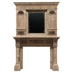 Antique English Victorian period, carved oak fireplace with an integrated mirror