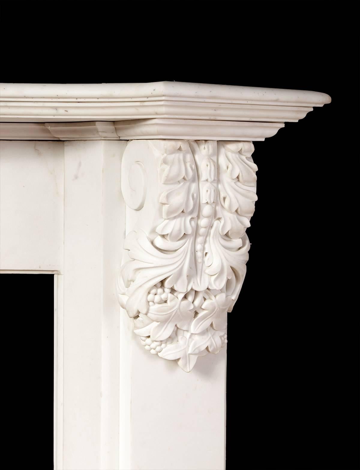 The fireplace features beautifully carved corbels set on canted jambs, scrolled and carved with floral detail at the bottom. The deep shelf is serpentine shaped and has moulded edges.

Made in London during the 1830s, the William IV period.

 