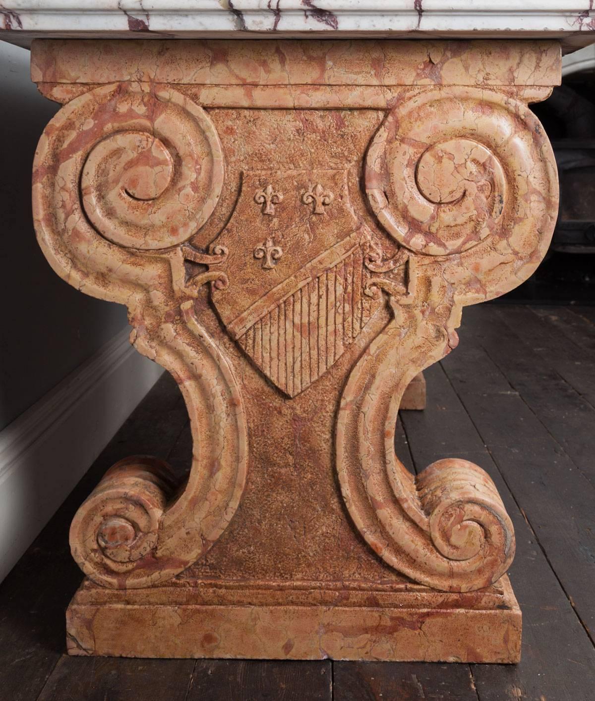 A very stylish antique Italian marble console or side table, in the Baroque taste. The C-scrolled supports carved from single blocks of Rosa Verona marble, the Breccia Viola marble top with moulded edge.

 