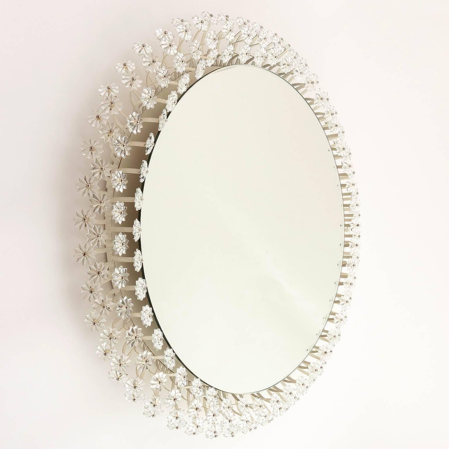 One of two large round wall mirrors with illuminated background and hundreds of lucite blossoms by Emil Stejnar for Rupert Nikoll, Austria.
The price is per mirror. They will be sold individually or as pair.

This mirror was designed in 1955 for the