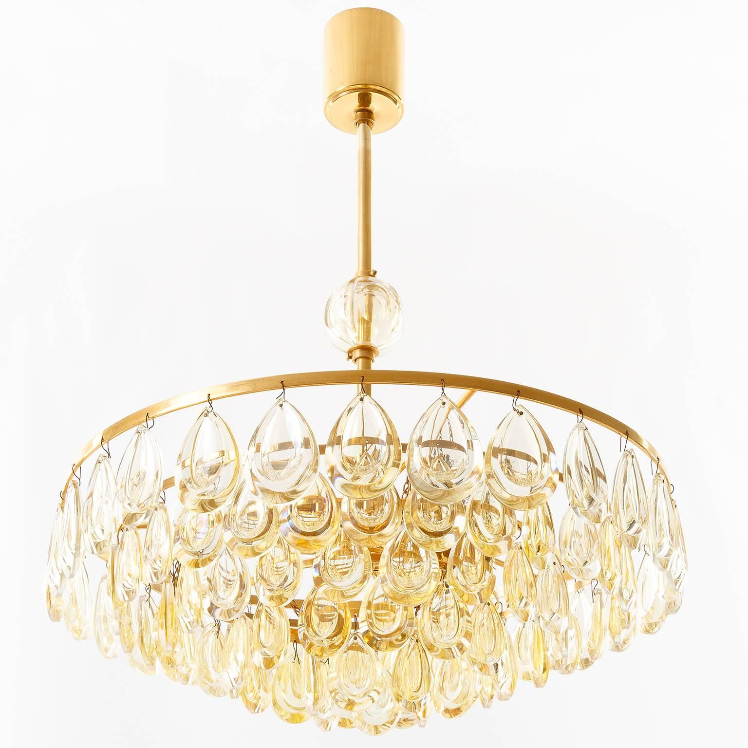 A wonderful and rare version of a gilt brass hollywood regency chandelier with amber tone glass crystal balls by Palwa (Palme & Walter), Germany, manufactured in Mid-Century, circa 1960. 
The light fixture takes four E14 candelabra screw base 40W