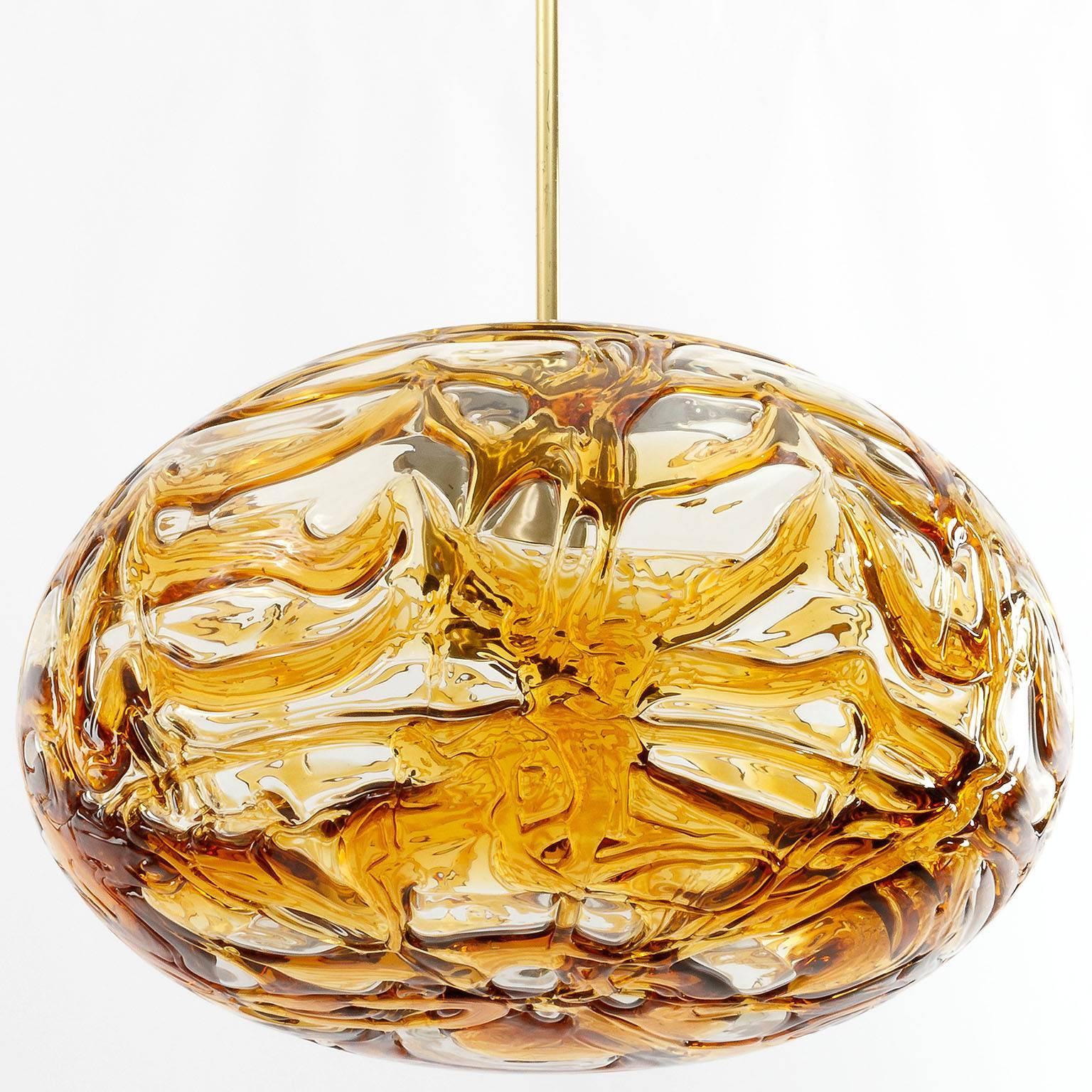 German Doria Pendant Light, Textured Amber Glass Globe and Brass, 1970