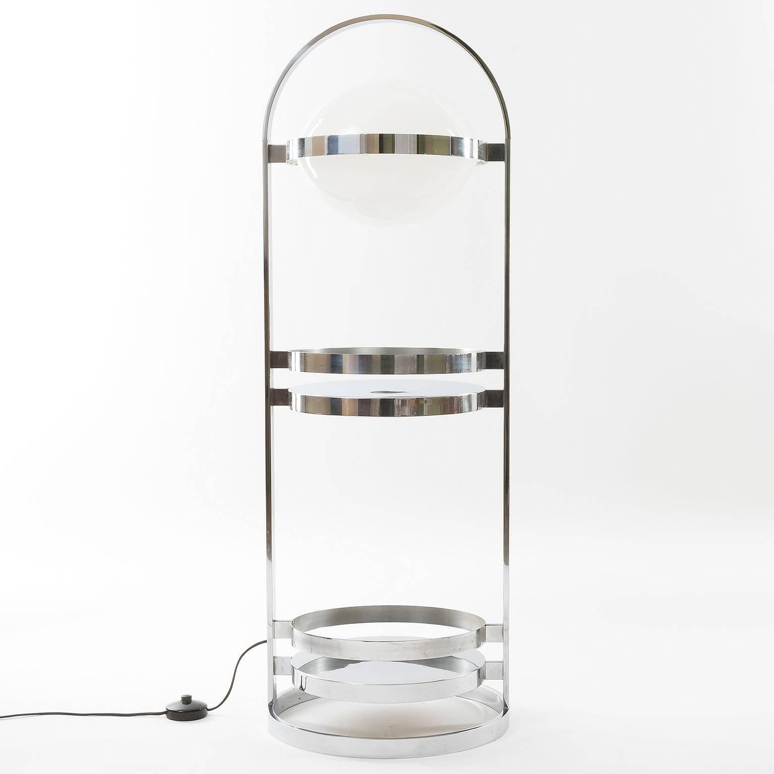 A rare Sapce Age floor lamp with two shelfs by Vest Leuchten, Austria, manufactured in Mid-Century in 1970s. A chromed metal frame holds an illuminated acryl glass globe. This item was a selected object for a design centre (see label).
