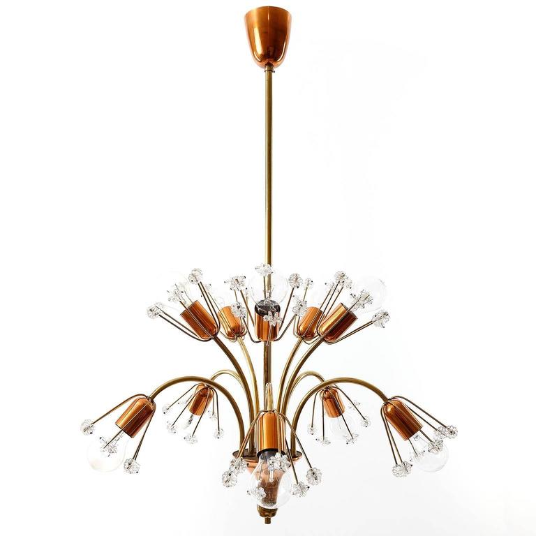 A beautiful chandelier / pendant light in the form of a bunch of flowers by Emil Stejnar for Rupert Nikoll, Vienna, Austria. An original vintage piece manufactured in Mid-Century (1950s-1960s). It is made of brass, copper and hand-cut crystals. It