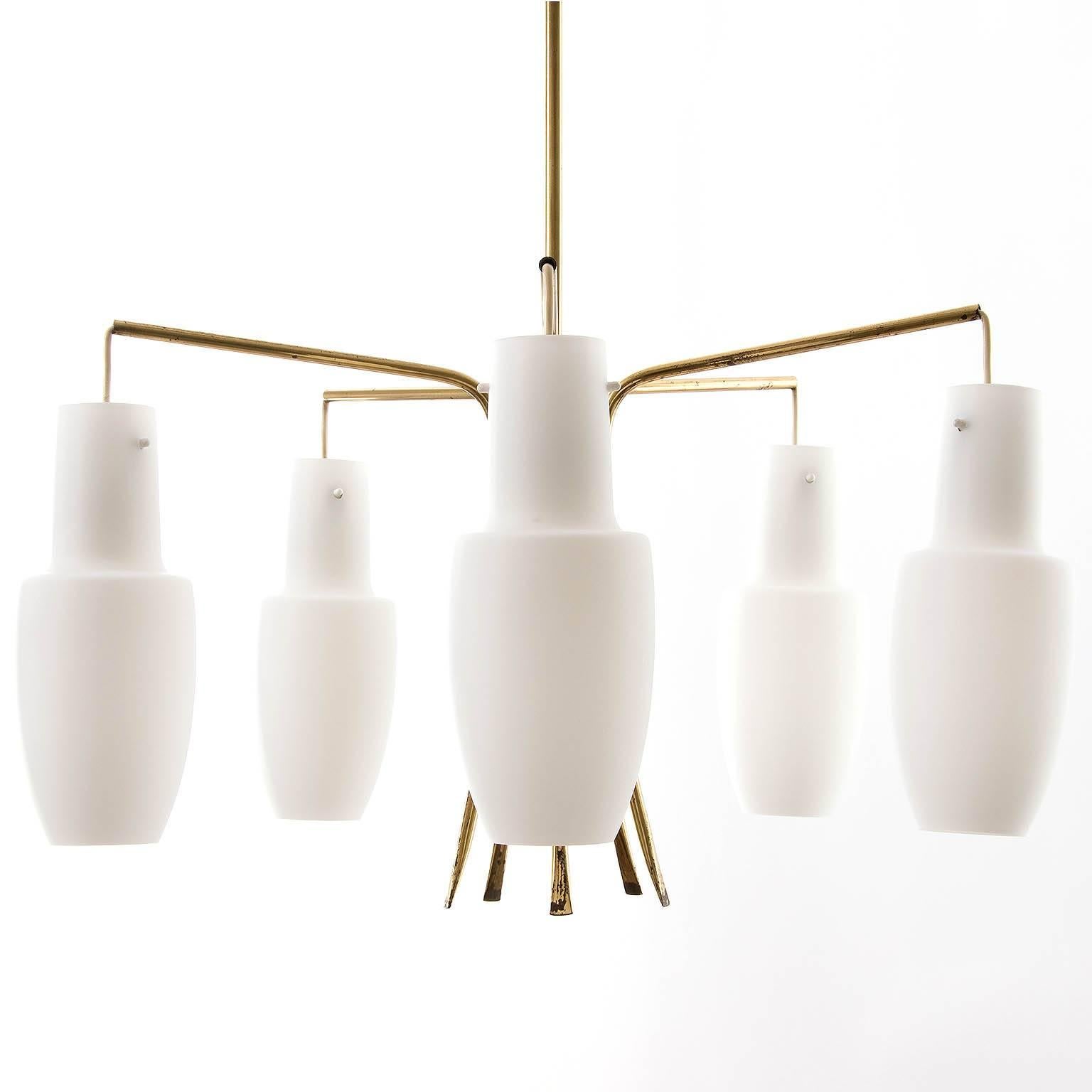 An Austrian pendant light fixture by Rupert Nikoll, manufactured in Mid-Century, circa 1960 (late 1950s or early 1960s). White opaline glass lamp shades hang on a five-arm brass frame. The light has five sockets for E14 candelabra screw base