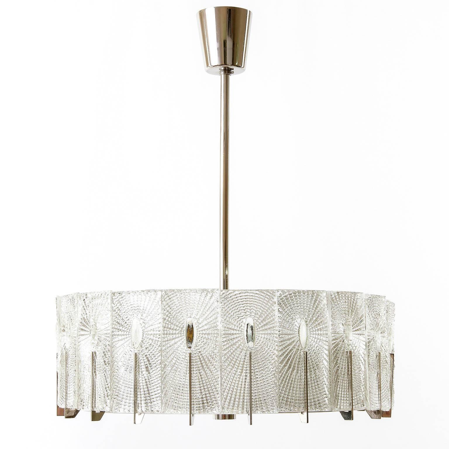 Two rare and exceptional textured glass and chrome and nickel light fixtures by Rupert Nikoll, Austria, manufactured in Mid-Century, circa 1950. The glass structure is in the style of the lights of J.T. Kalmar.

The lamps can be used as chandelier