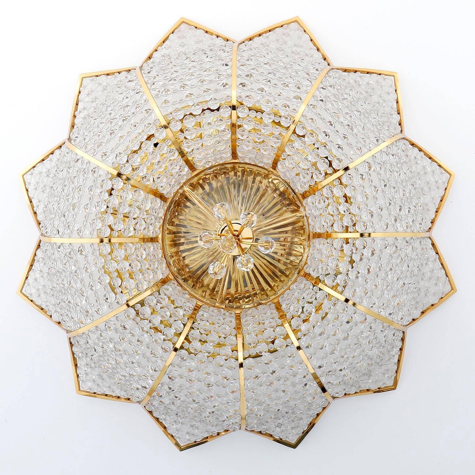 Only one light is available.
One of two beautiful ceiling light fixtures by Palwa (Palme and Walter), Germany, manufactured in Mid-Century, circa 1970 (1960s-1970s). 
They are made of gilded / gilt / gold-plated brass and hundreds of cut crystal