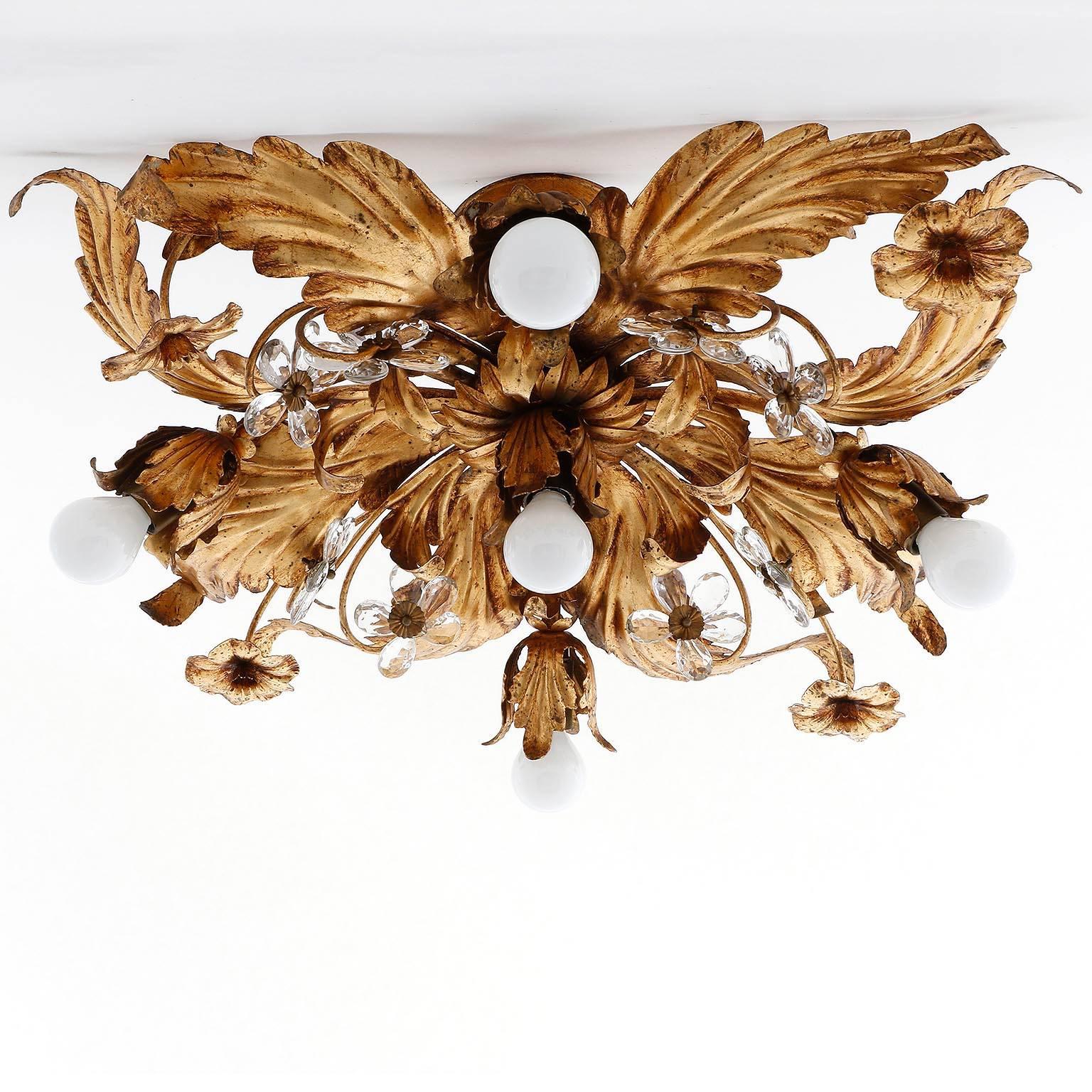 A floral flush mount light from Italy, manufactured in Mid-Century between 1960 and 1970.
It is made of antique gilt or bronzed metal and cut crystal glass. The lamp has five sockets for LEDs or small Edison base bulbs (5 x max. 40 W).

There are