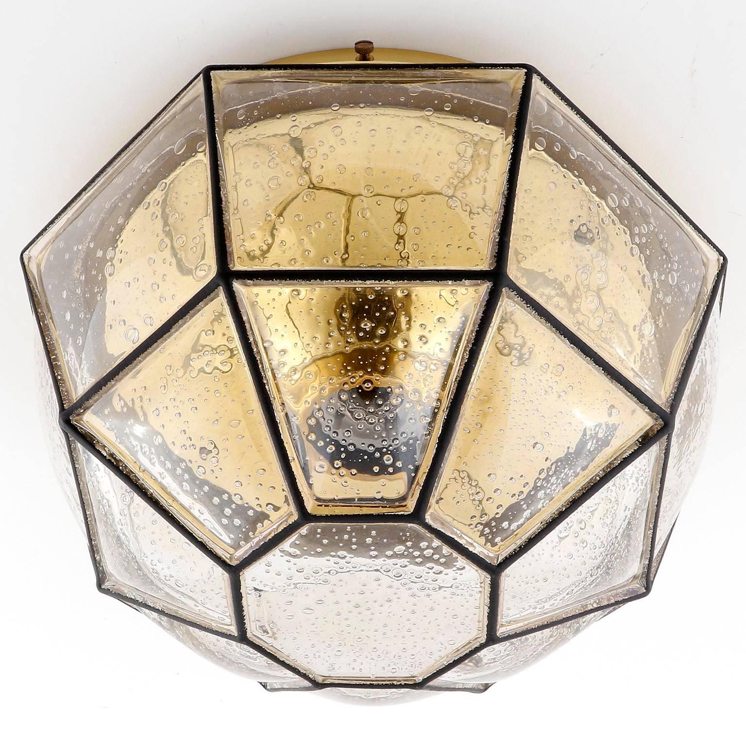 A beautiful flush mount or wall light fixture by Glashütte Limburg, Germany. Amber tone 'iron' bubble glass with polished brass base. 
The lamp takes a single medium or standard screw base bulb up to max. 75W. 