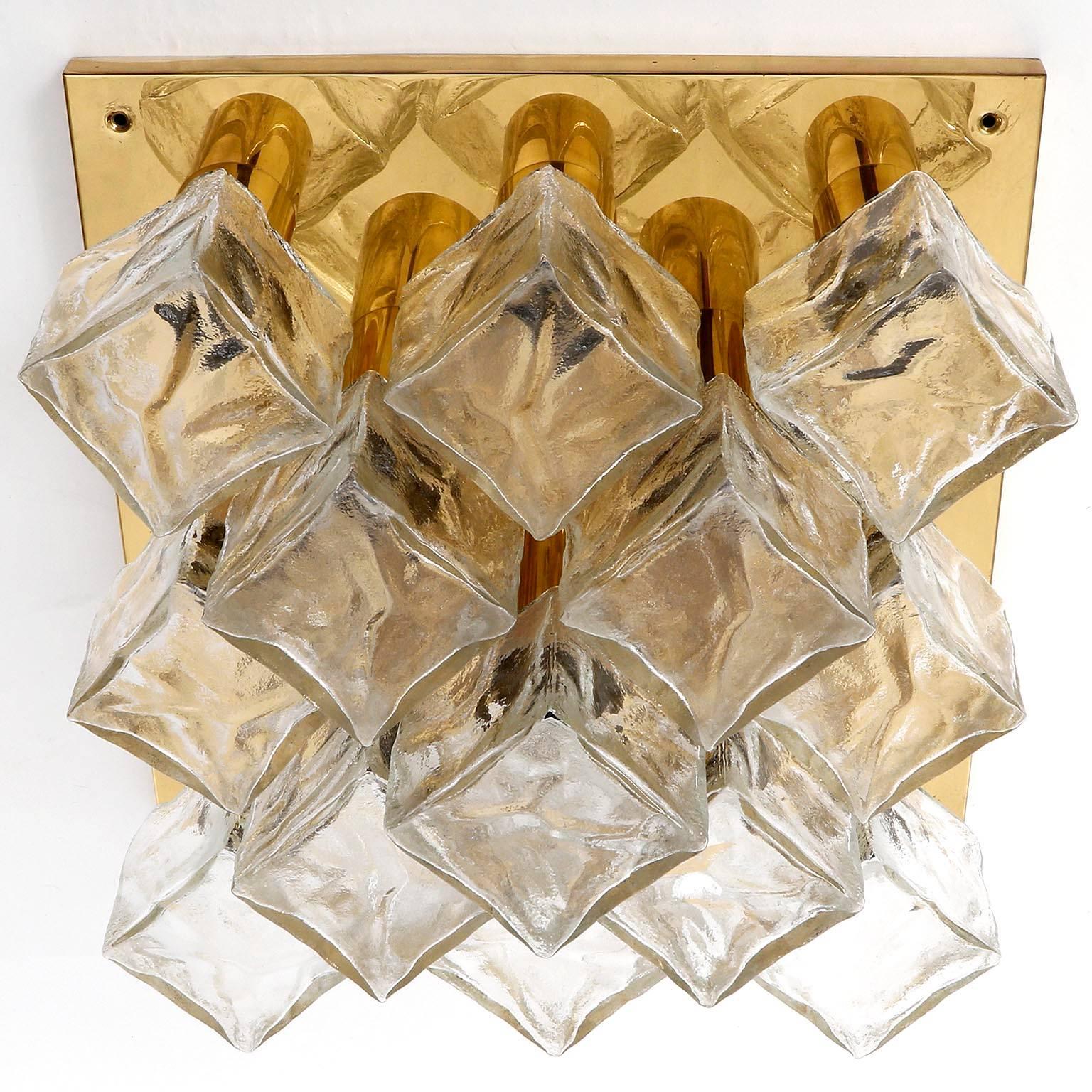 One of three fixtures model 'Cubus' (German 'Würfel') by Kalmar, Austria, manufactured in midcentury, circa 1970 (end of 1960s and beginning of 1970s).
They are made of polished brass and frosted cubic glasses. There are 13 small screw base bulbs