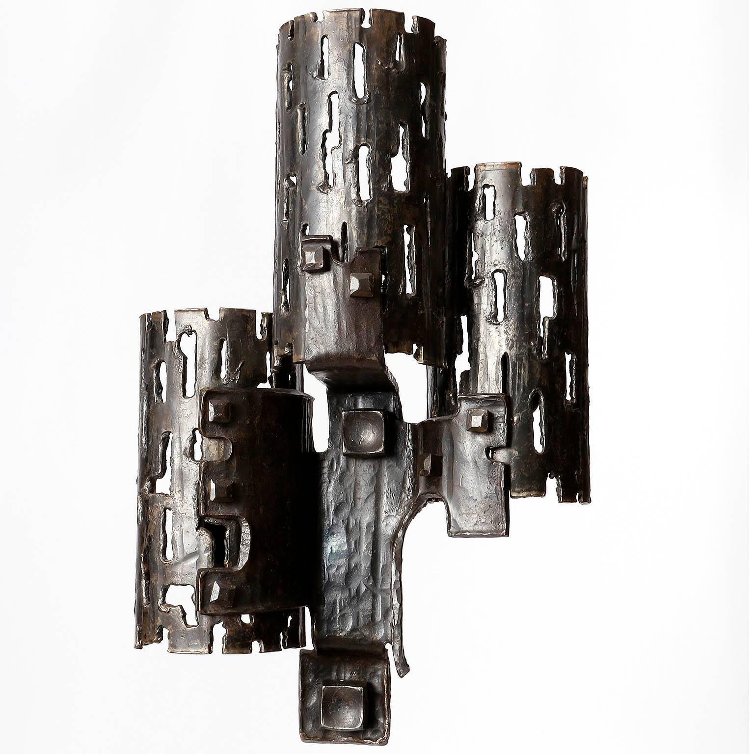 A pair of one-of-a-kind Brutalist style wall lamps made of metal with great patina, manufactured in Germany in Mid-Century, circa 1970 (end of 1960s or early 1970s). 
A massive and very impressive craftsmanship. Unqiue and handmade pieces.
Each lamp