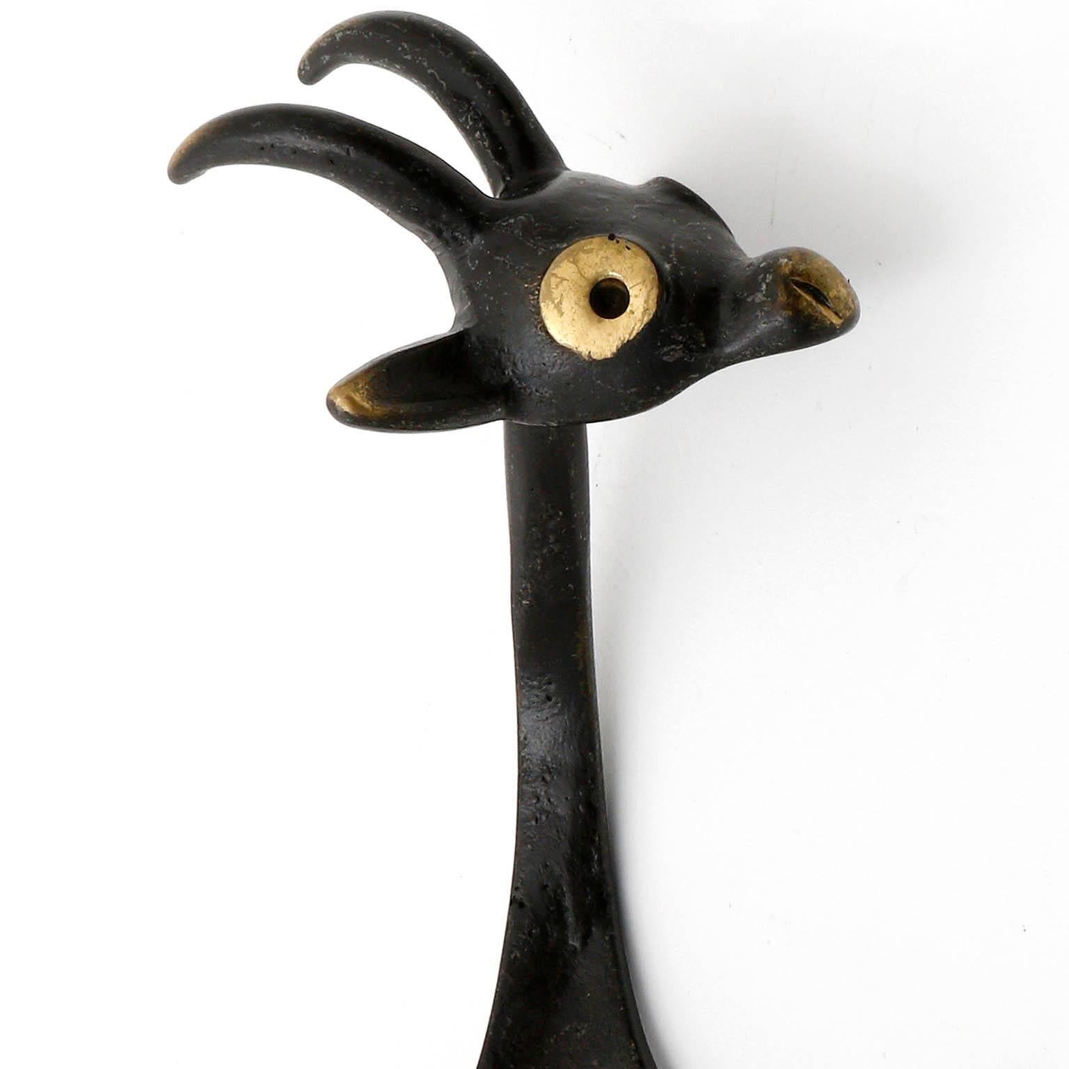 A rare coat wall hook in the form of a goat by Walter Bosse, Austria, manufactured in Mid-Century, circa 1950.
It is made of blackened and partly polished brass. Wear of use, lovely patina.

There are also other animal hooks in the form of a