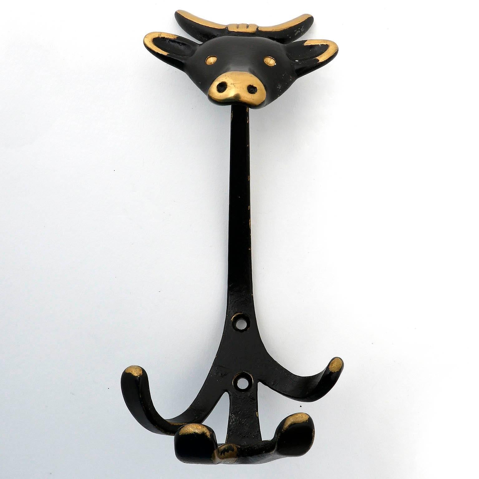 Three nice coat wall hooks in the form of a bull by Walter Bosse, Austria, manufactured in Mid-Century, circa 1950.
They are made of blackened and partly polished brass. Wear of use, lovely patina.
The price is per hook. The will be sold