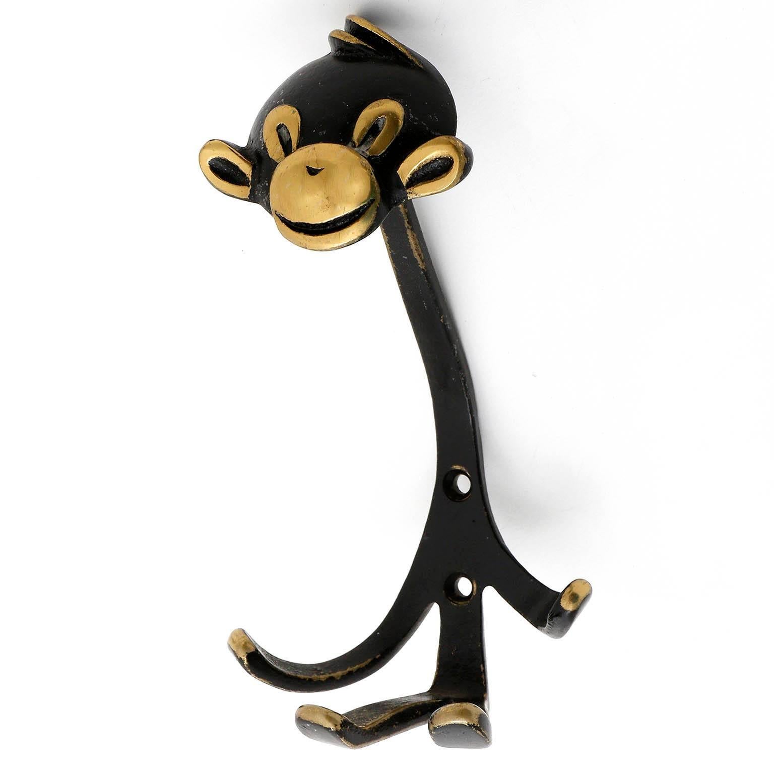 A coat wall hook in the form of a monkey by Walter Bosse, Austria, manufactured in Mid-Century in 1950s.
It is made of blackened and partly polished brass. Wear of use, lovely patina.

There are also other animal hooks in the form of a goat, a