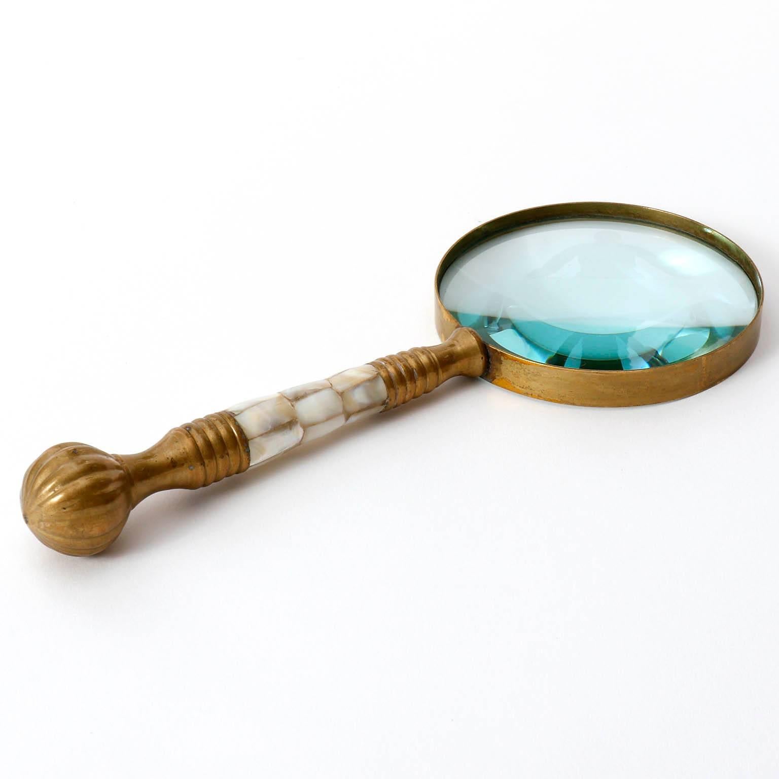 A magnifying glass made of brass, glass and mother-of-pearl. Very nice patina on brass.
